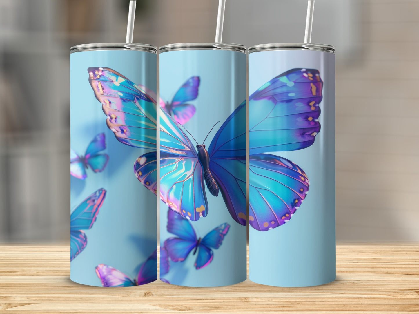Three tumblers featuring iridescent blue butterflies on a light blue background.