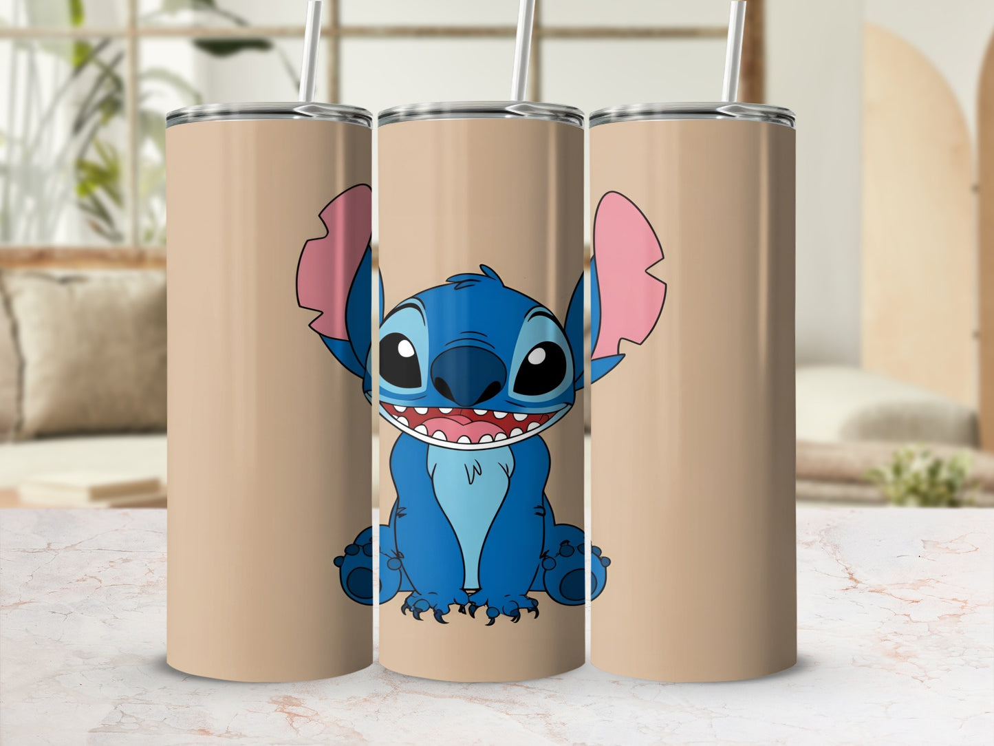 Stitch character illustration on three tan tumblers with straws.
