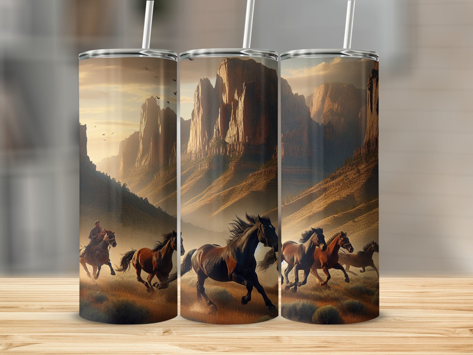 Three tumblers with a Western landscape and galloping horses.