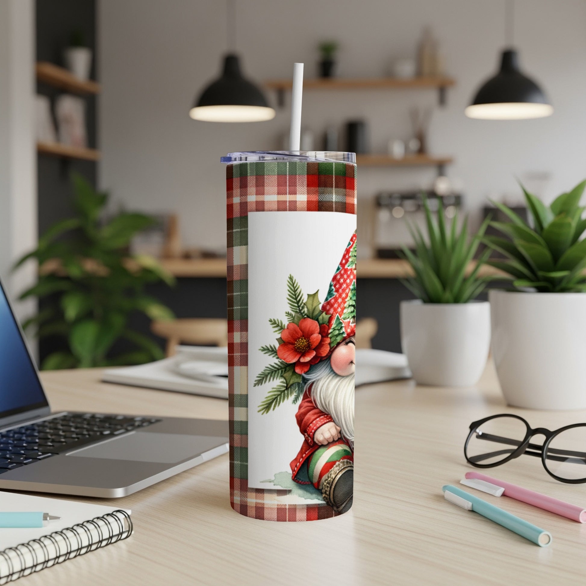 Tartan gnome with poinsettias on a white rectangle, on a desktop.