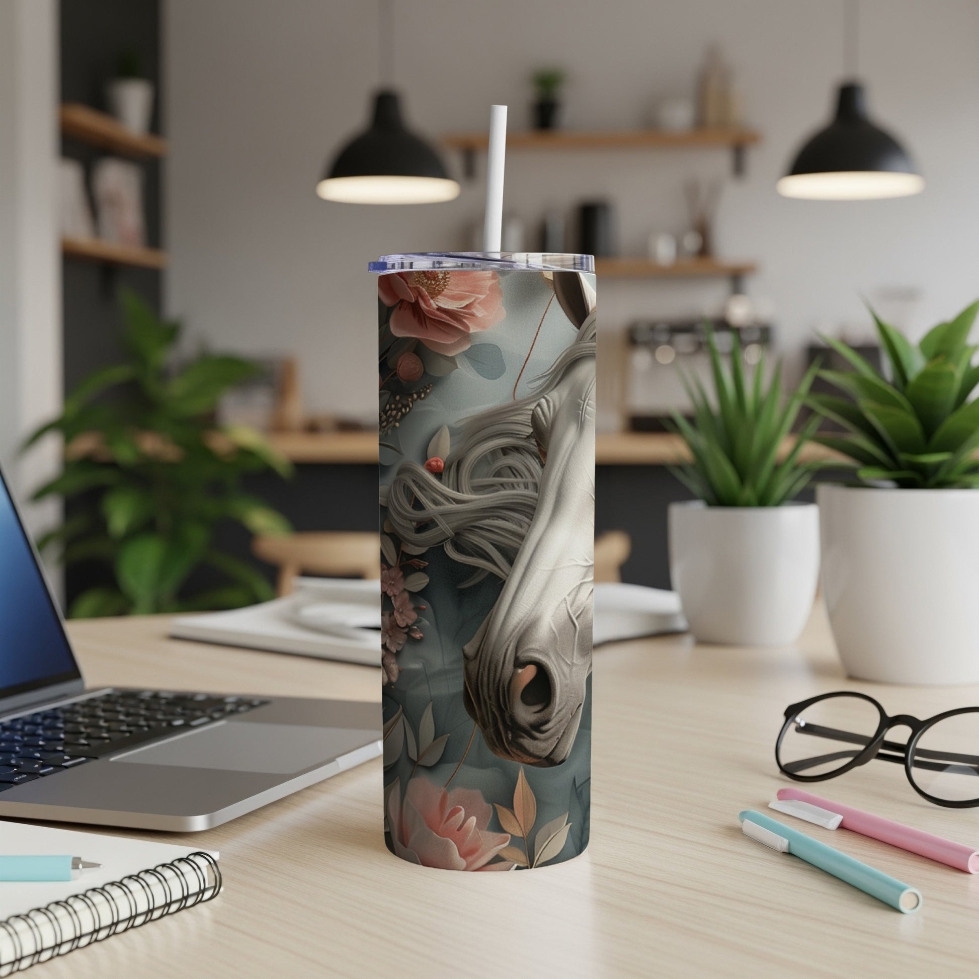 Close-up of a white horse's head with floral accents on a stainless steel tumbler.