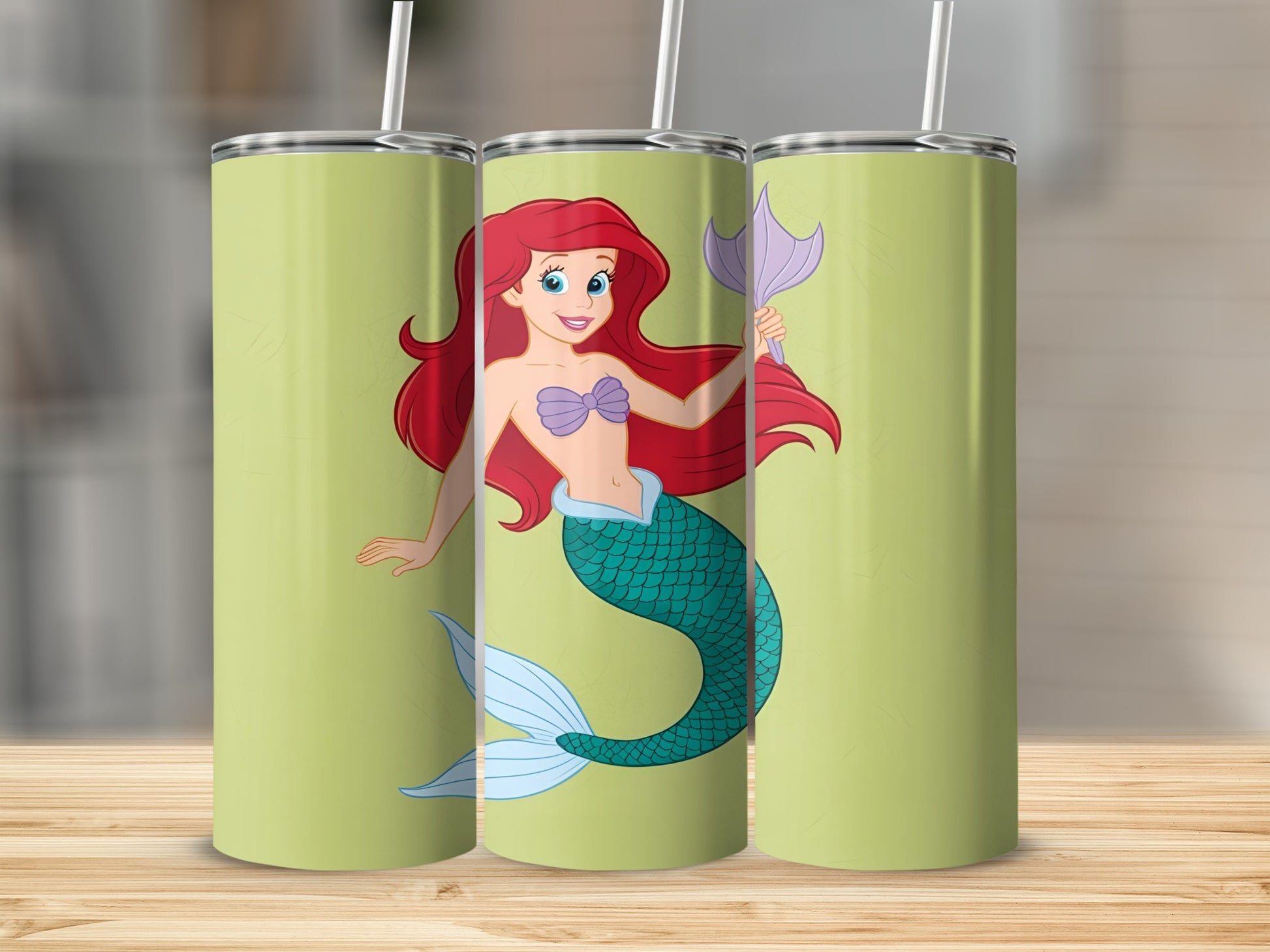 Ariel the mermaid with red hair and green tail on a light green background.