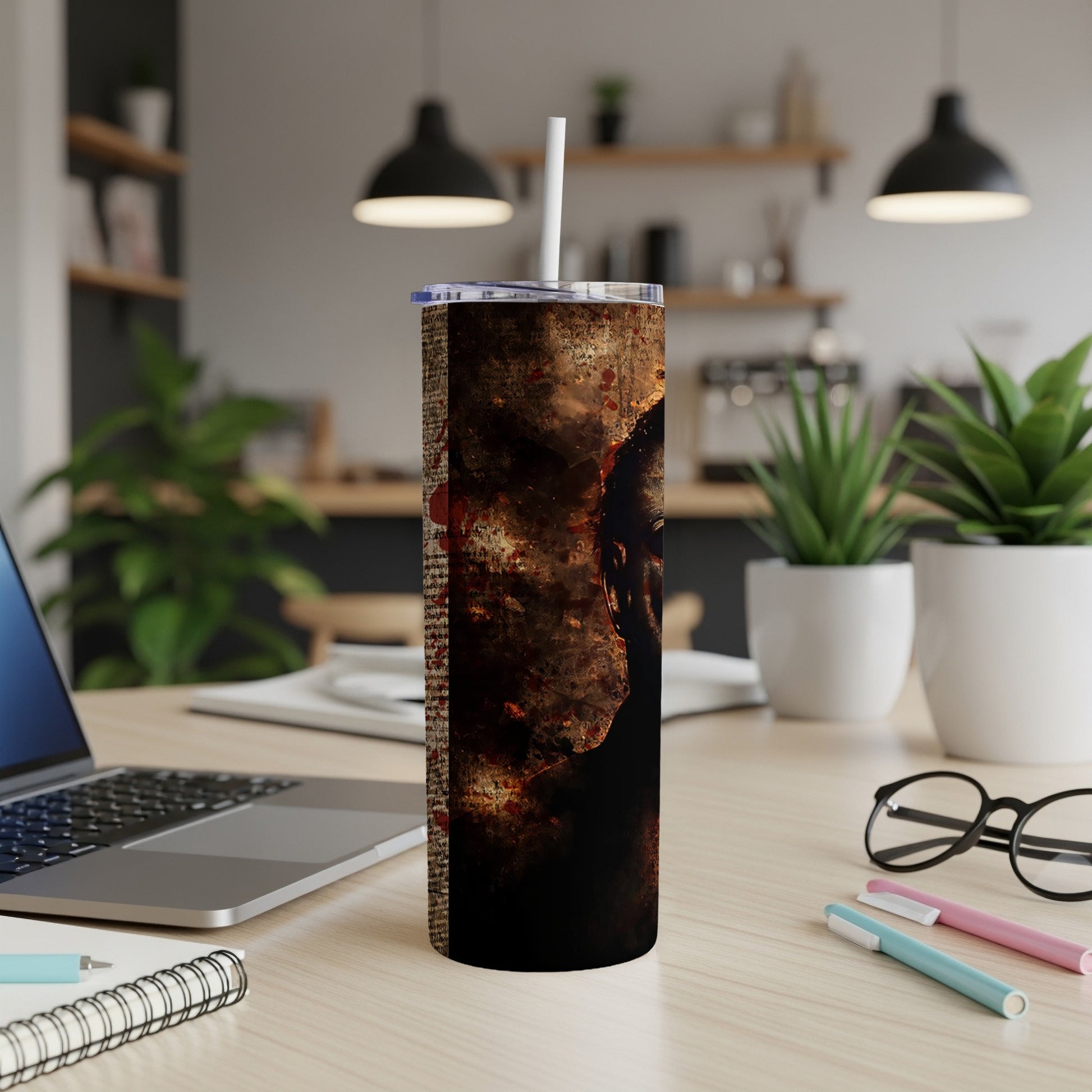 Tumbler with dark, textured design and partially visible face.