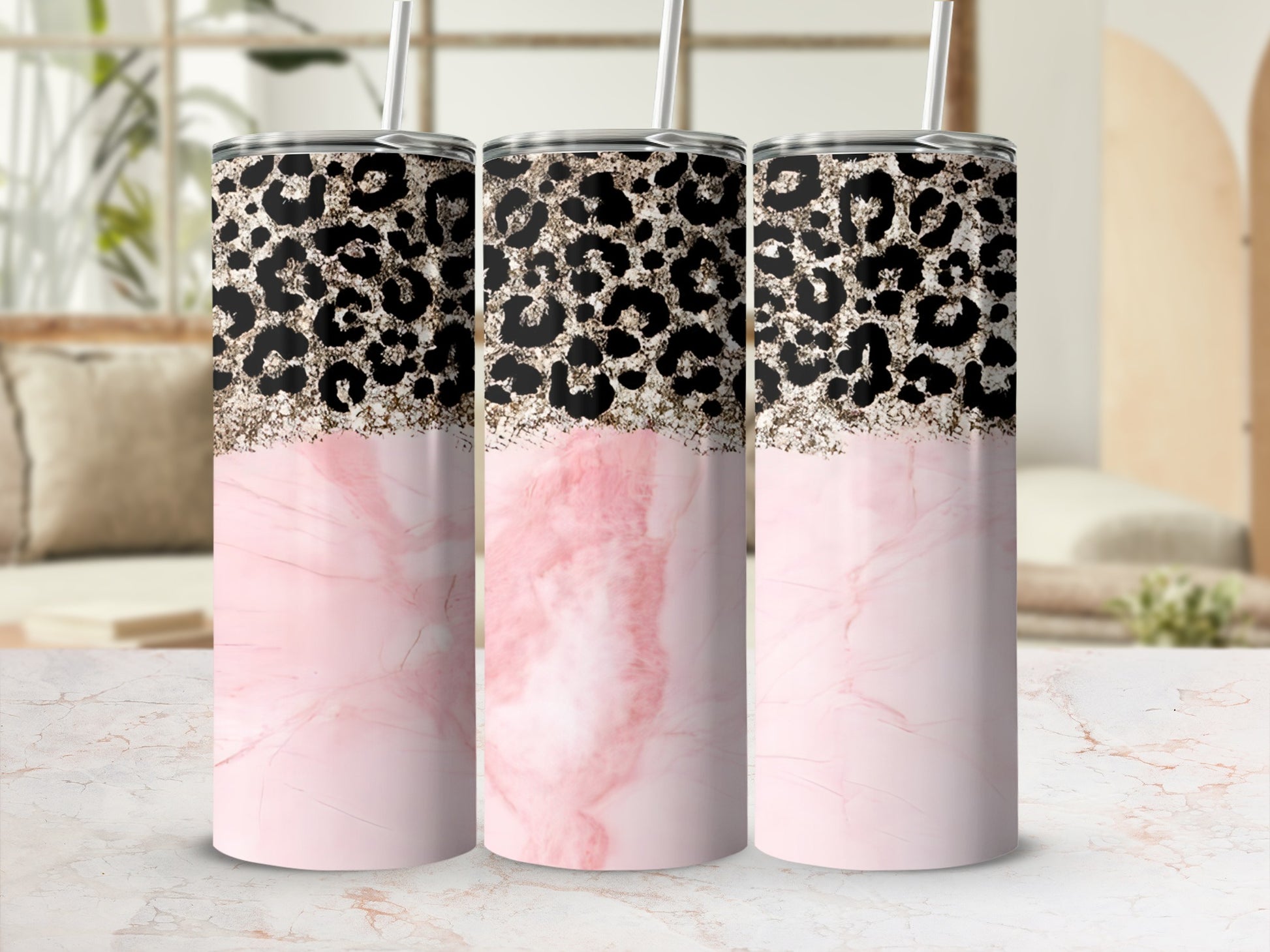 Three tumblers with pink marble and black leopard print designs.