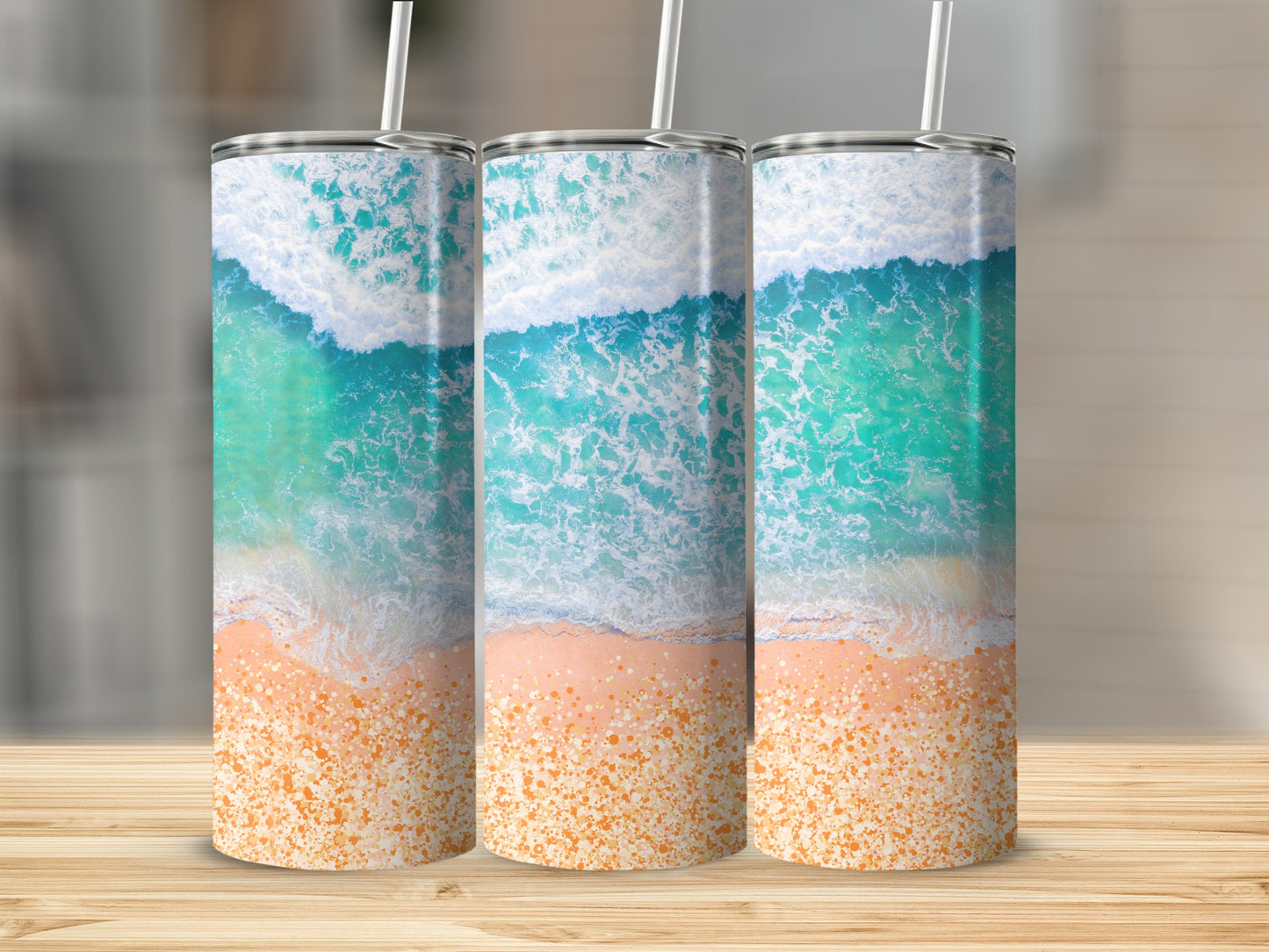 Three tumblers with a beach wave and sand design.