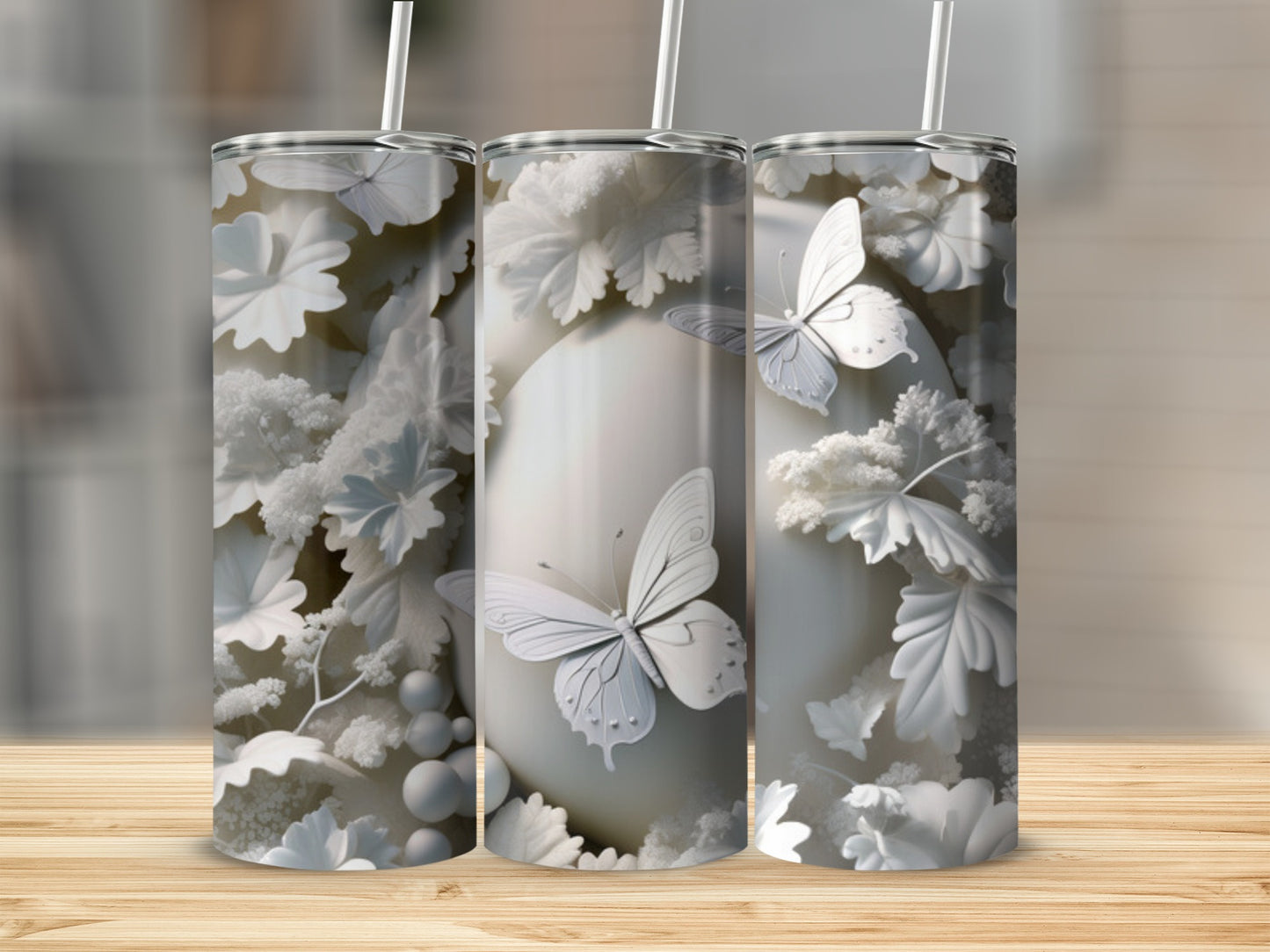 White butterfly and floral pattern on three tall cylindrical tumblers.