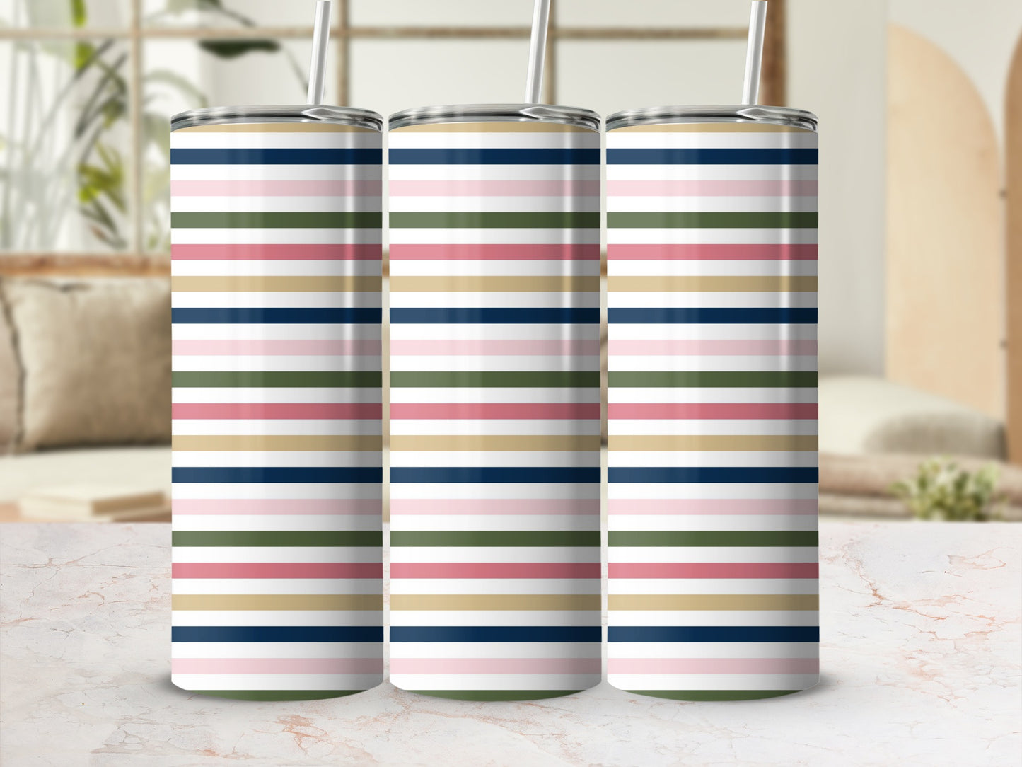 Three tumblers with a colorful horizontal stripe pattern on a marble surface.