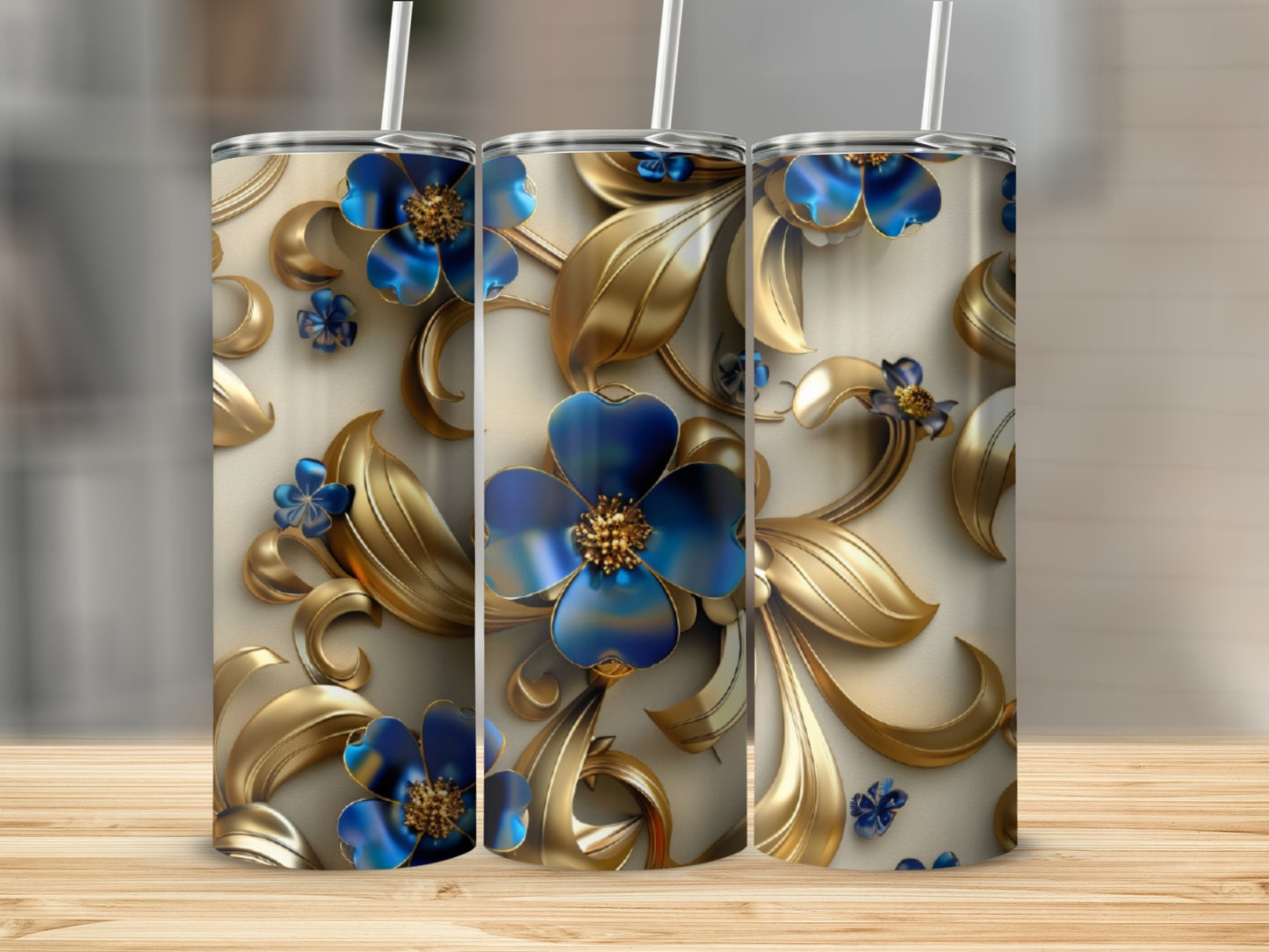 Three tumblers with gold floral and blue flower design.