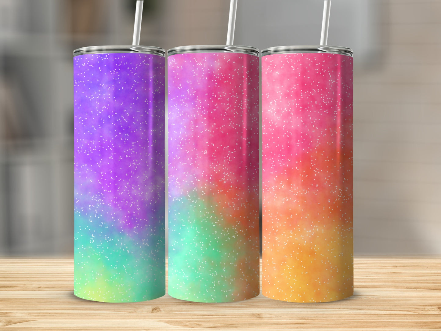 Three tumblers with ombre watercolor designs, from purple to green, pink to orange.