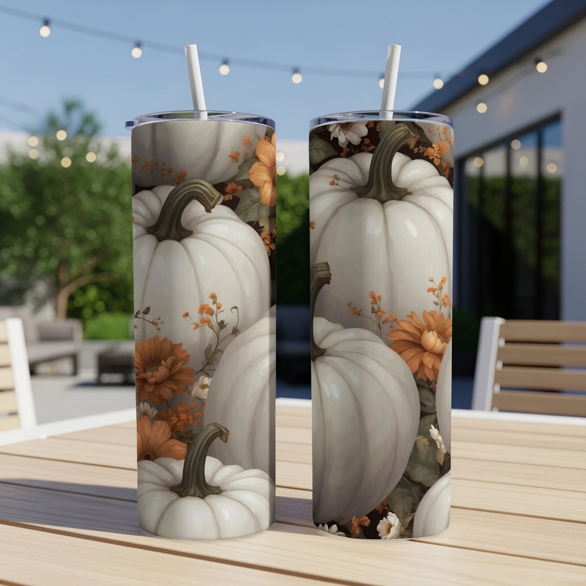Two white pumpkins with floral accents on a white tumbler.