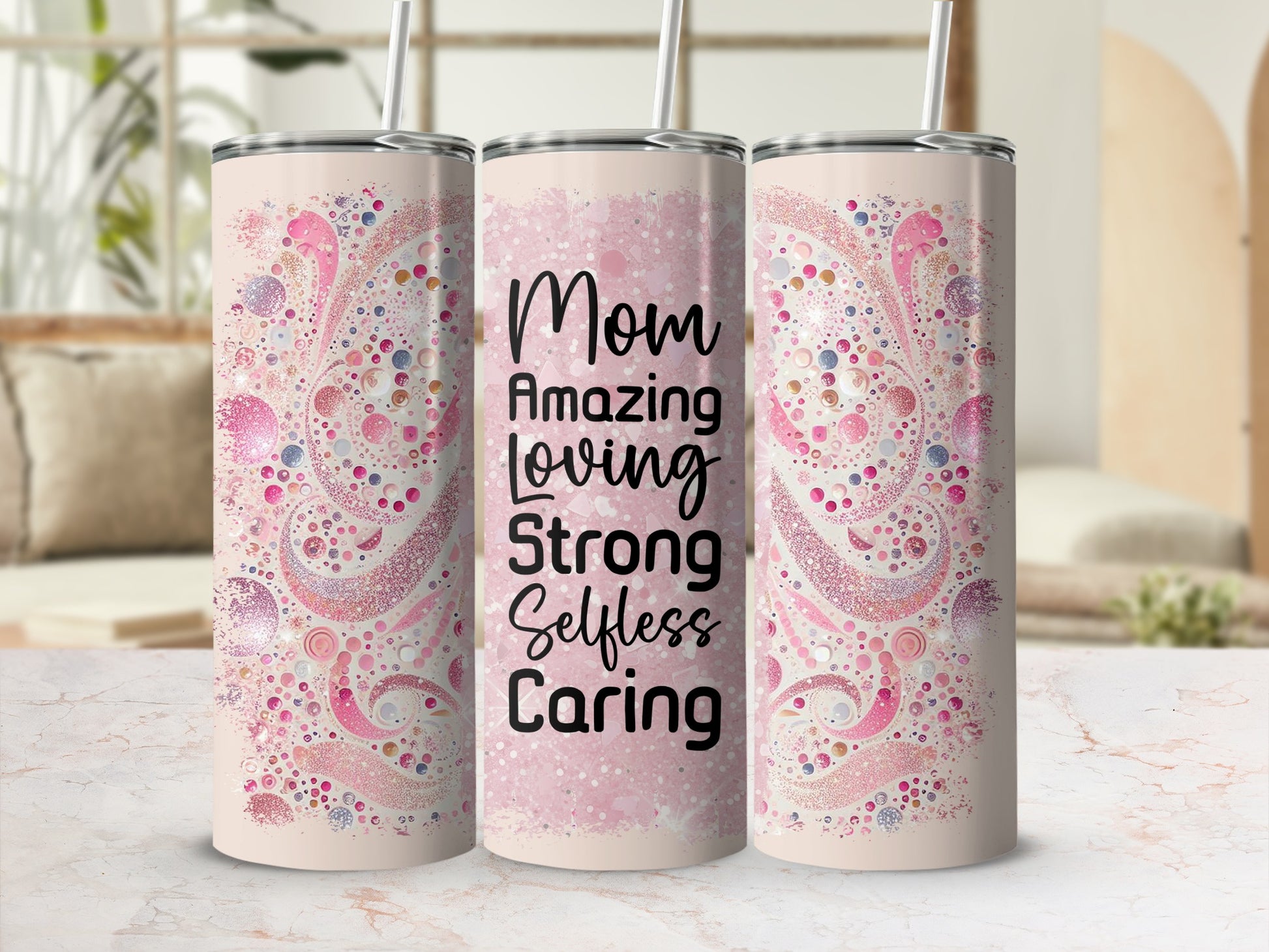 Pink tumbler with "Mom Amazing Loving Strong Selfless Caring" text and glitter design.