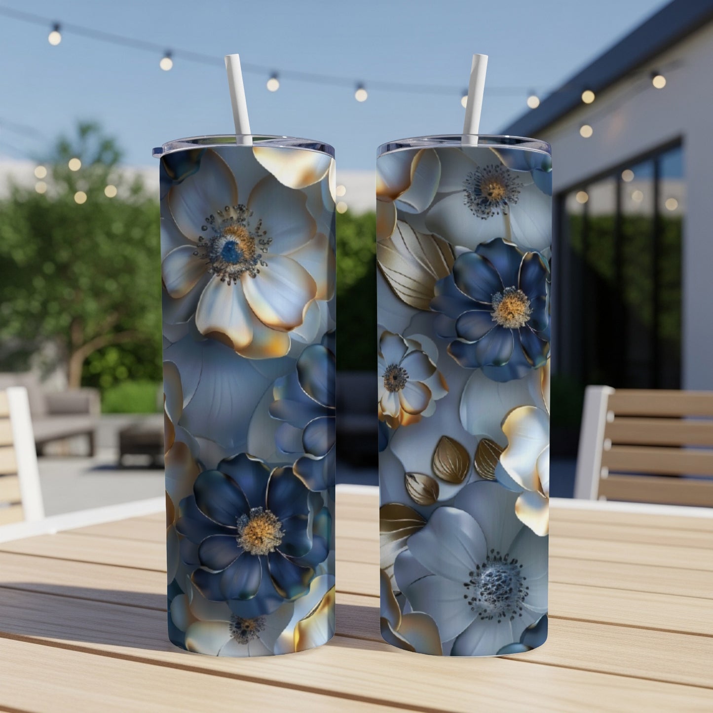 Two tumblers with blue and gold floral pattern on wooden table.