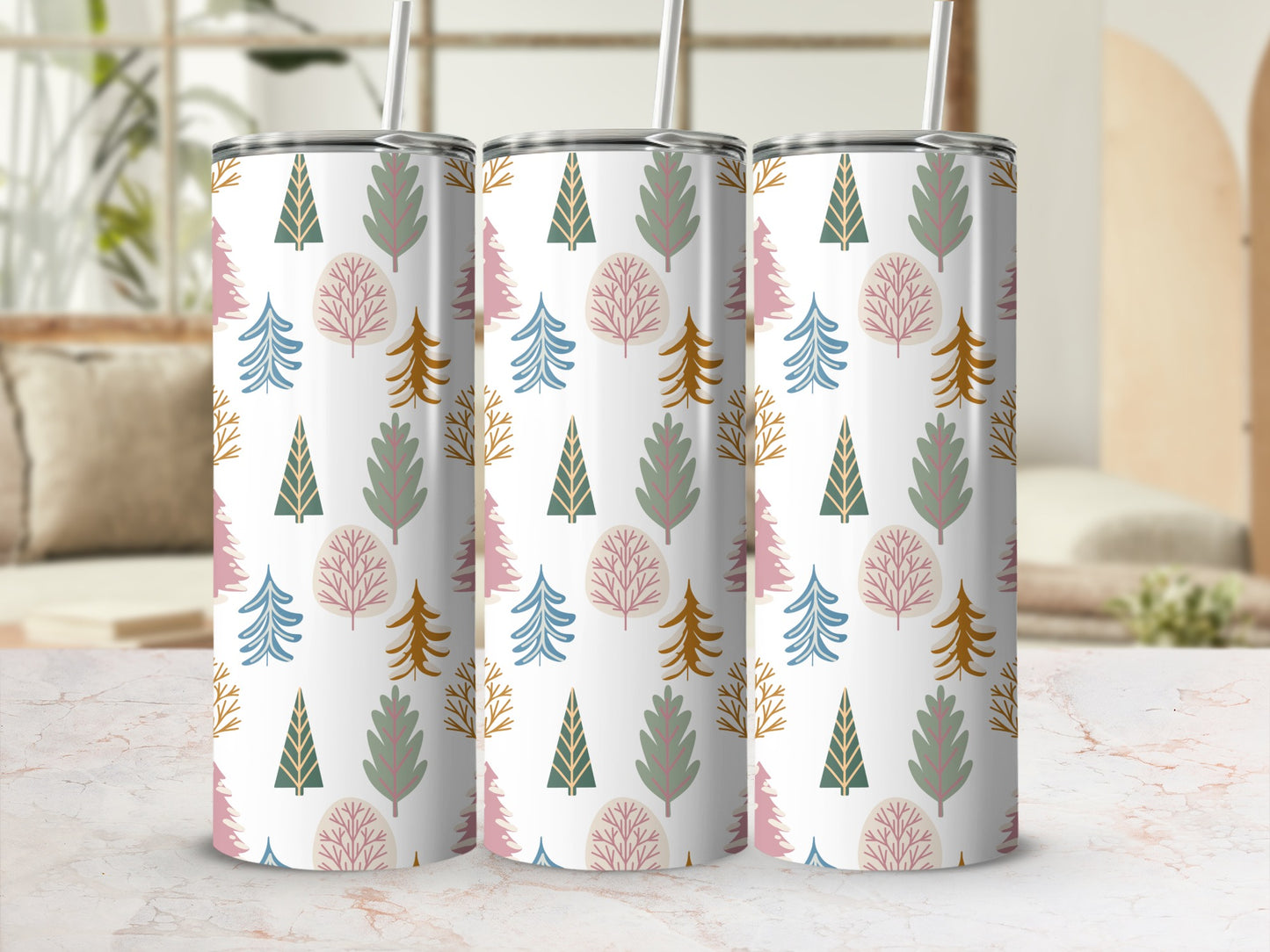 Three patterned tumblers with trees and geometric shapes on a marbled surface.