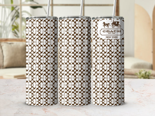 Three Coach pattern tumblers with straws, one displaying the logo and text.