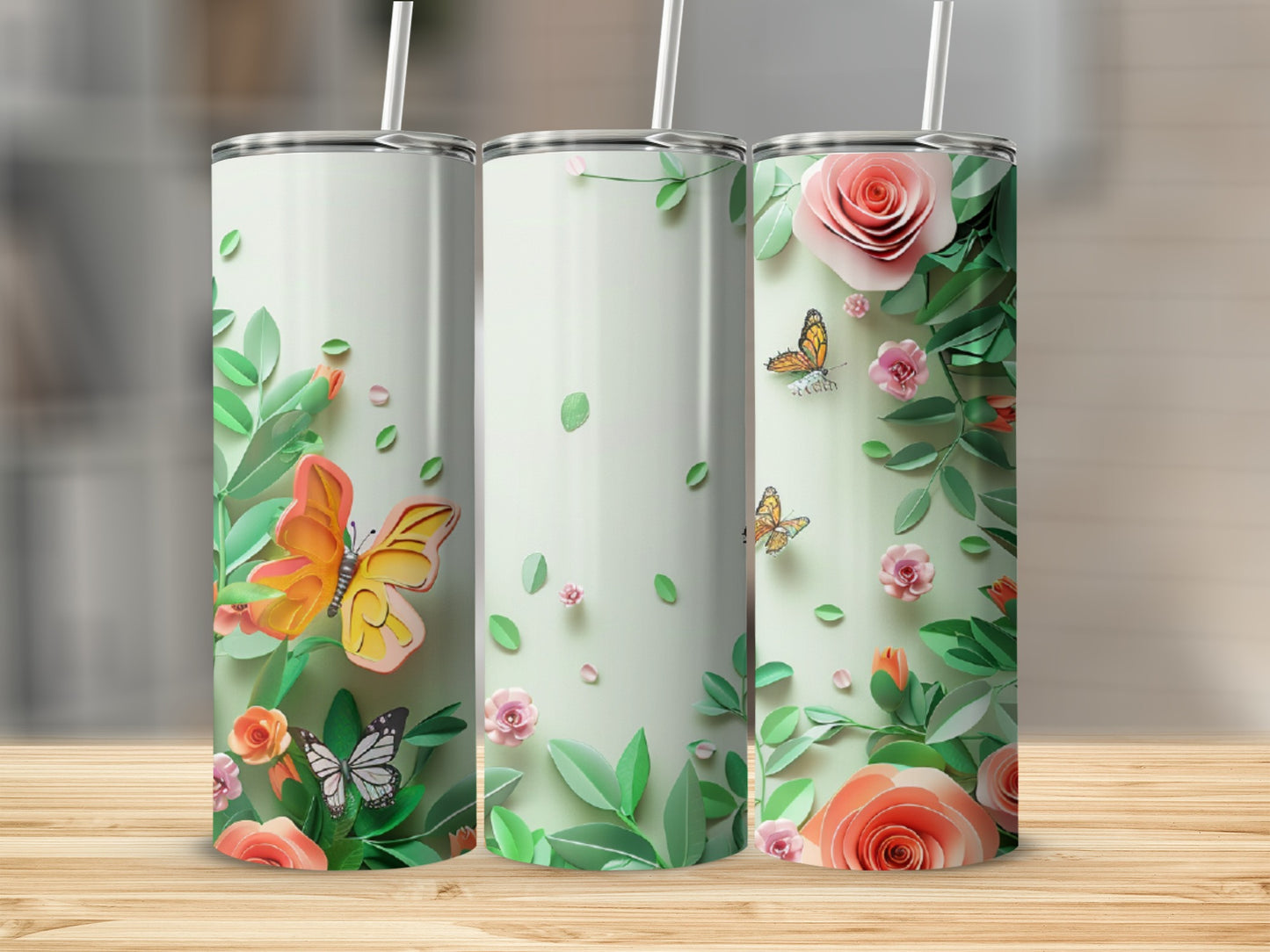 Three tumblers with floral and butterfly designs.