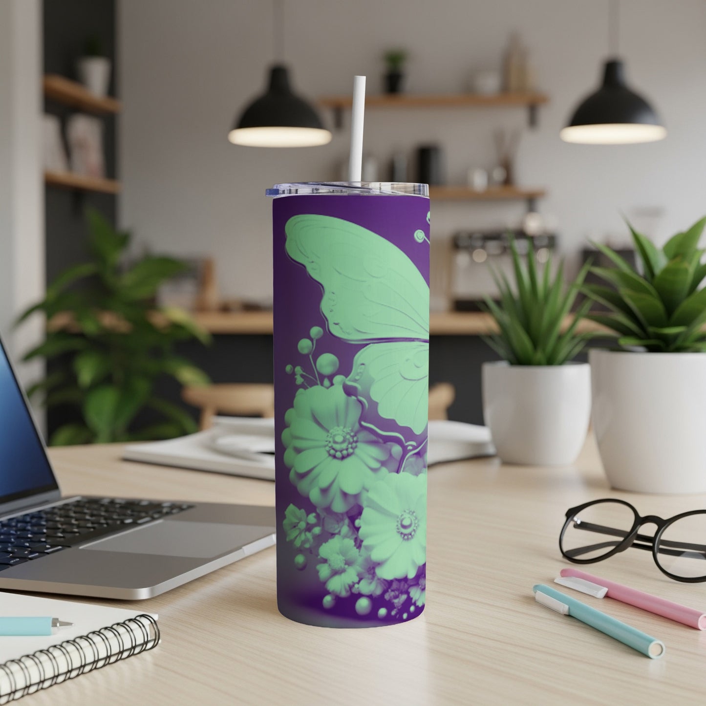 Purple tumbler with a light green butterfly and floral design, straw inserted.