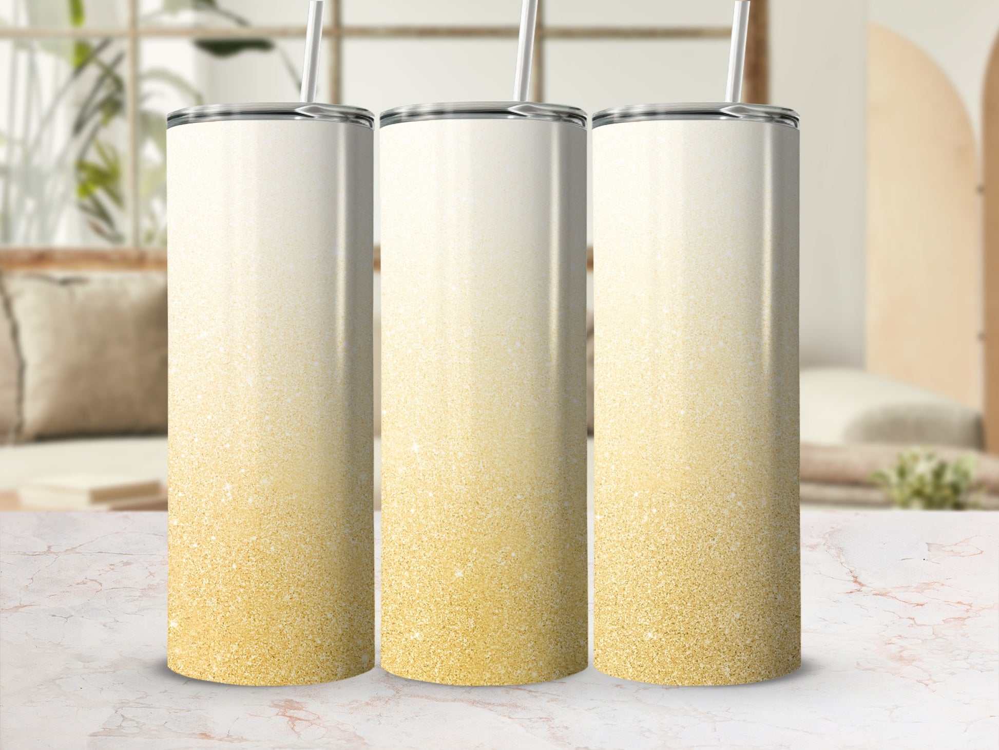 Three tall tumblers with gold glitter ombre design.