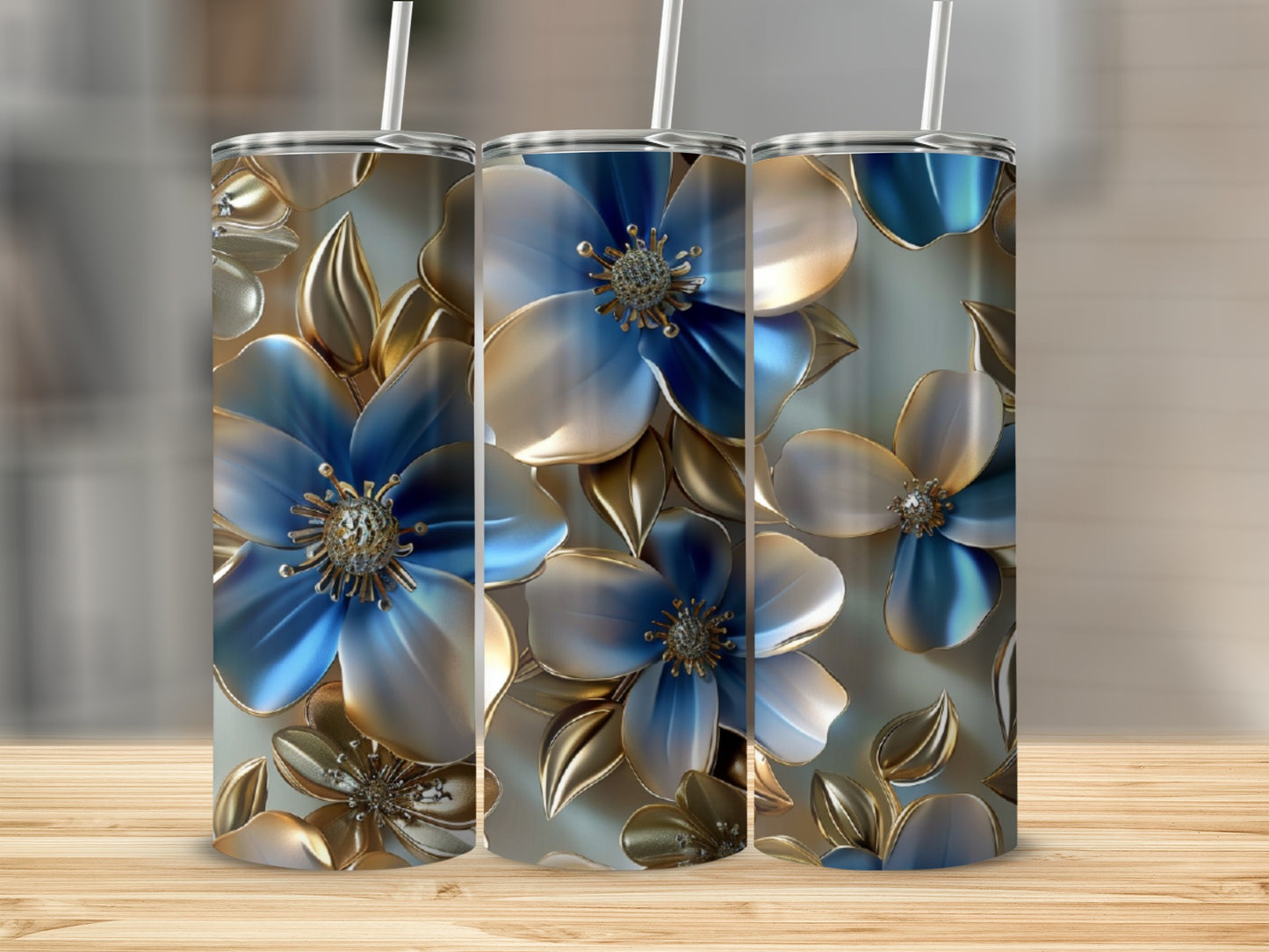 Three blue and gold metallic floral tumblers with straws.