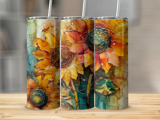 Three tumblers with vibrant, abstract sunflower designs and straws.