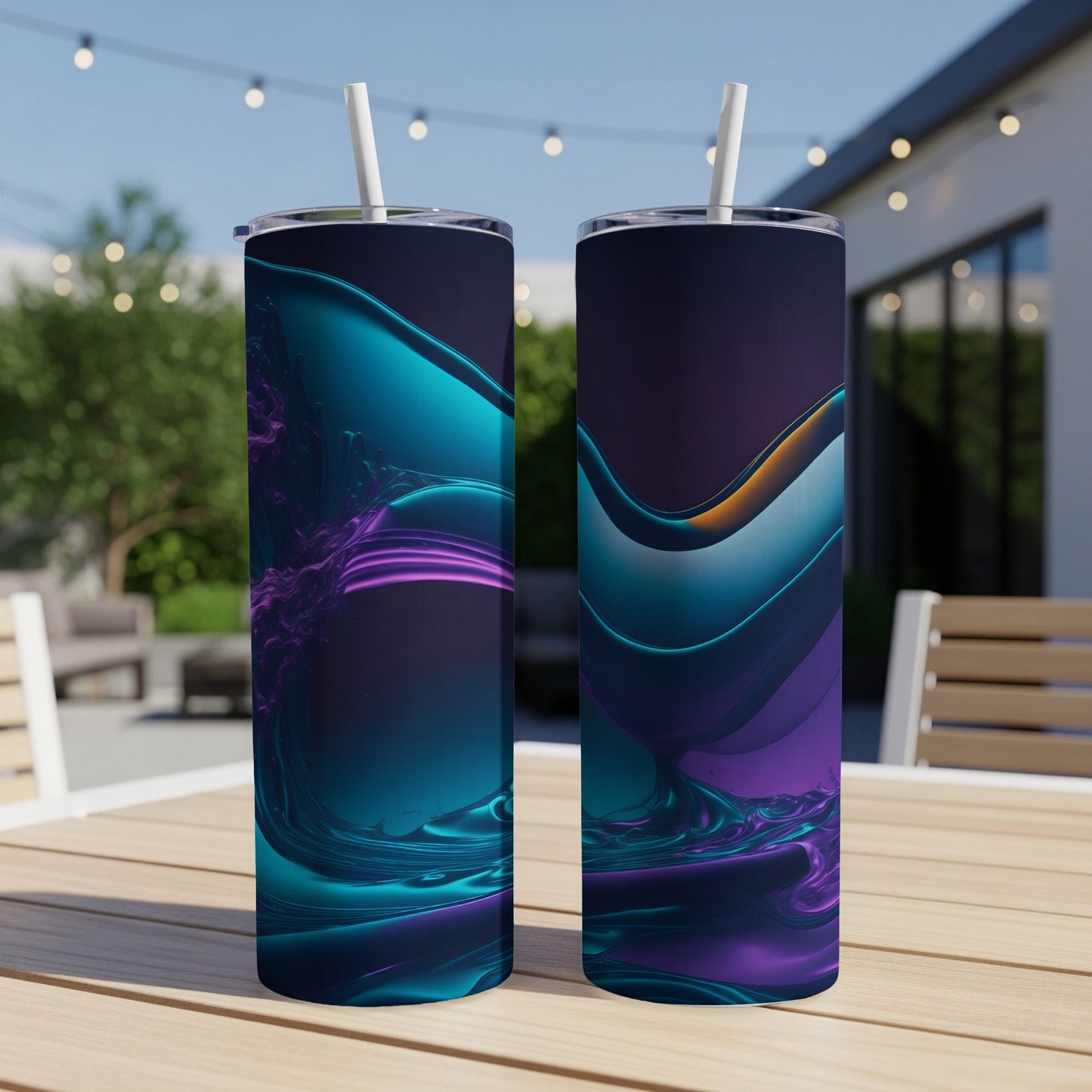 Two tall, colorful tumblers with abstract wave designs sit on a wooden table outdoors.
