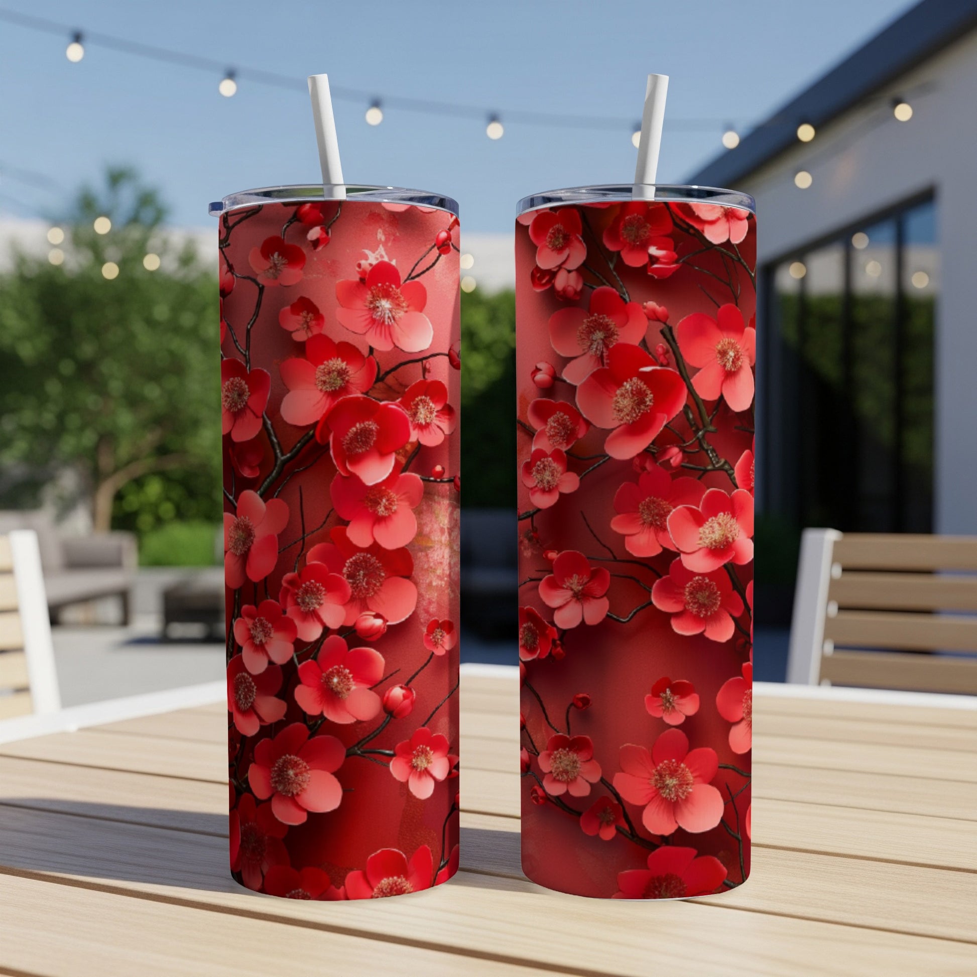 Two red tumblers with a detailed cherry blossom pattern.