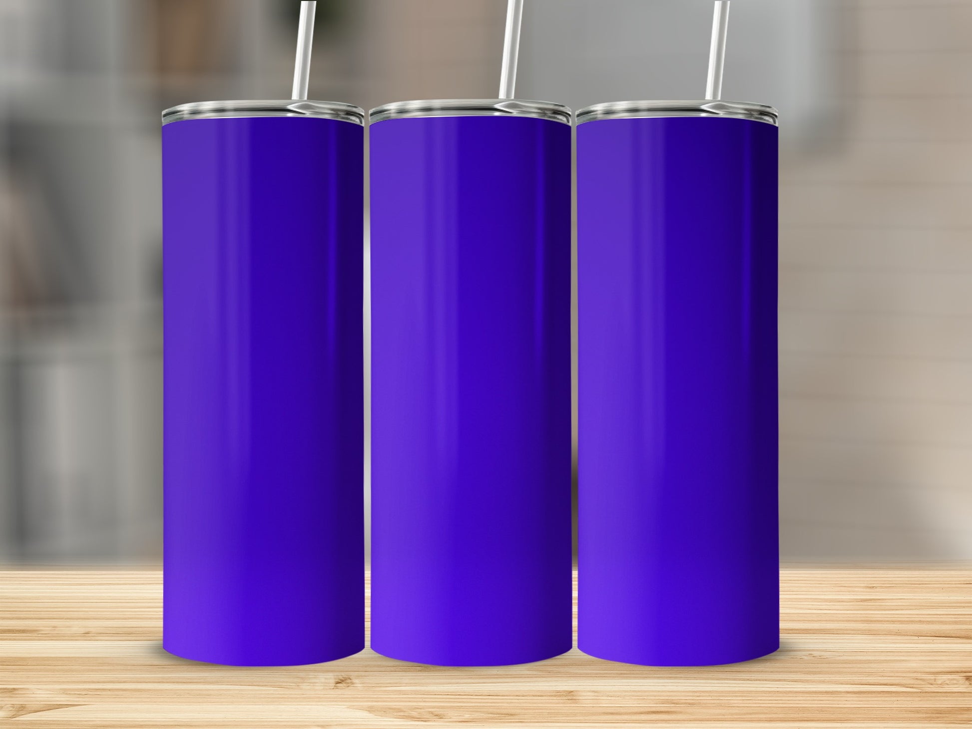 Three plain purple tumblers with white straws stand in a row.