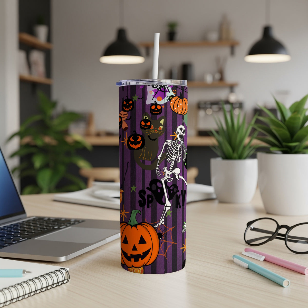 Purple striped tumbler with Halloween graphics, including a skeleton, black cat, and pumpkins.