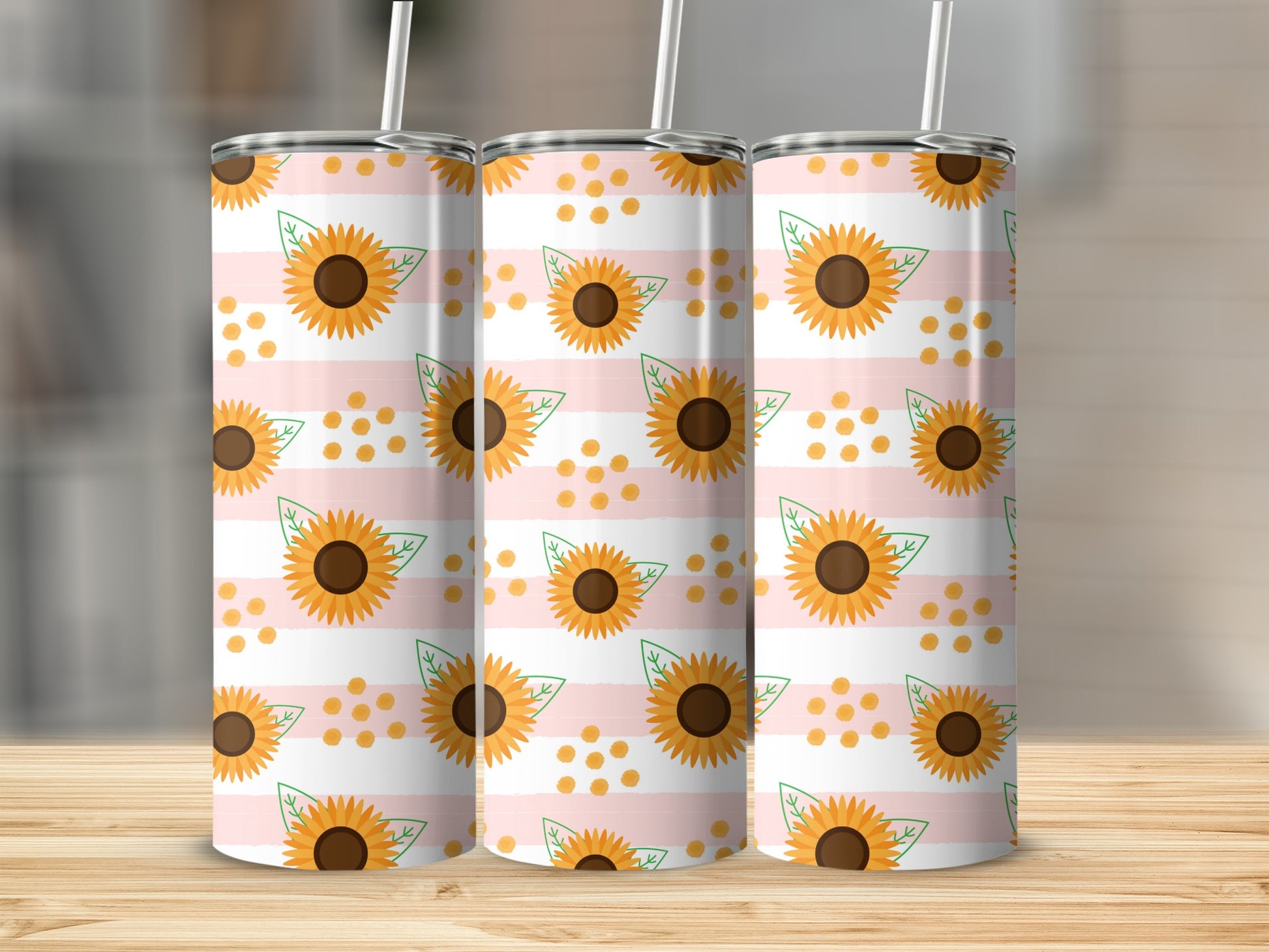 Three tumblers with pink and white stripes featuring sunflowers and orange dots.