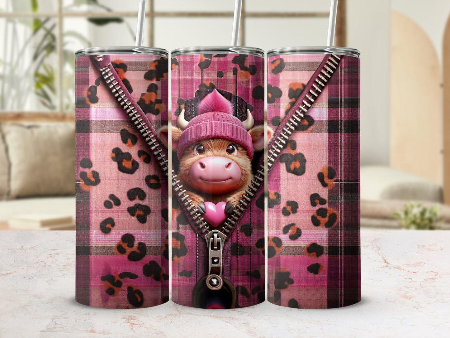 Pink plaid tumbler with zipper design revealing a smiling cow wearing a beanie.