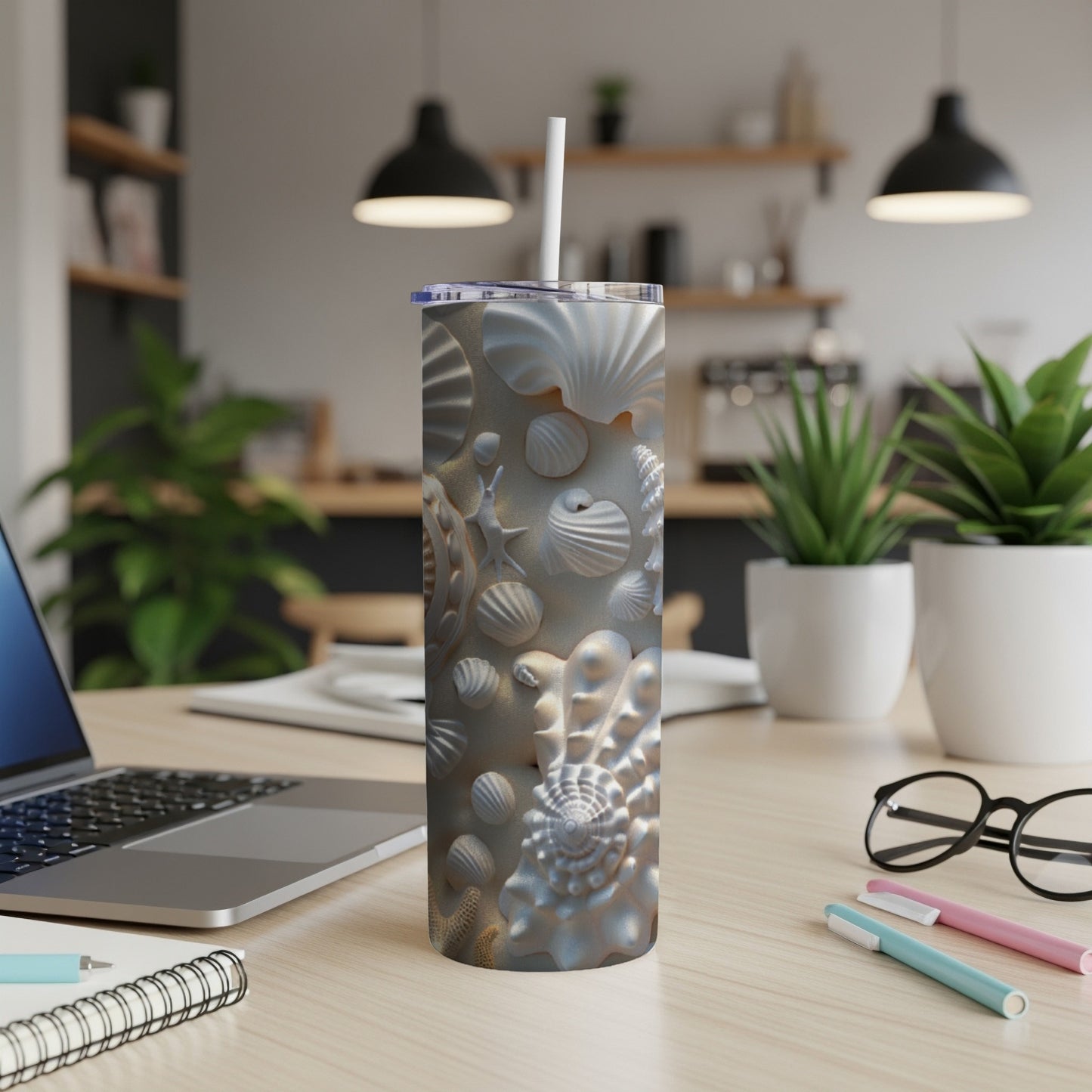 Seashell and starfish pattern on a white tumbler with a straw.
