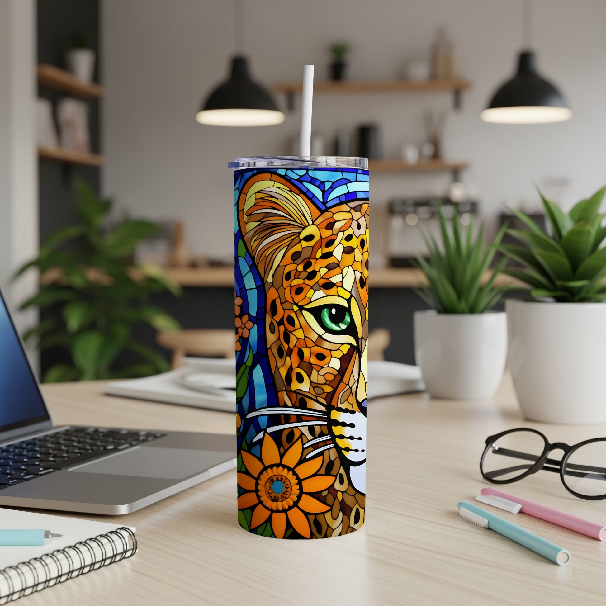 Leopard face mosaic design on a skinny tumbler with straw.