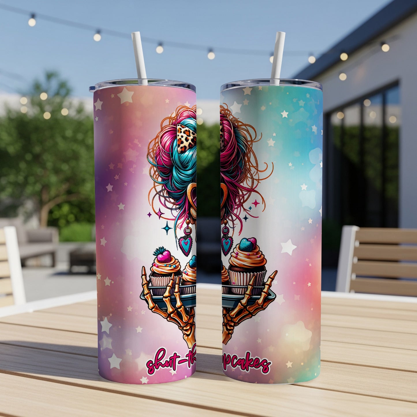 Two tumblers with colorful abstract design and skull holding cupcakes.