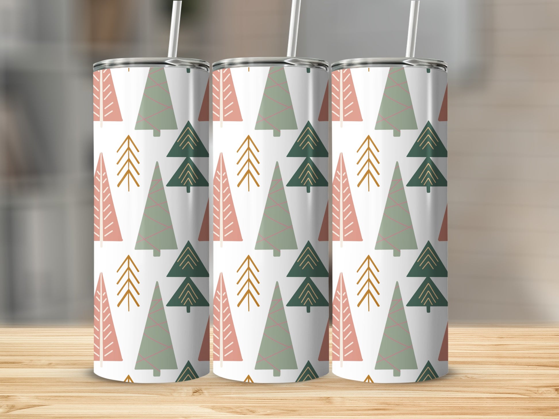 Three tumblers with a festive green and pink Christmas tree pattern.