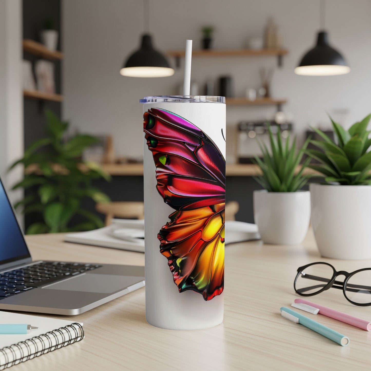 White tumbler with colorful butterfly wing design.