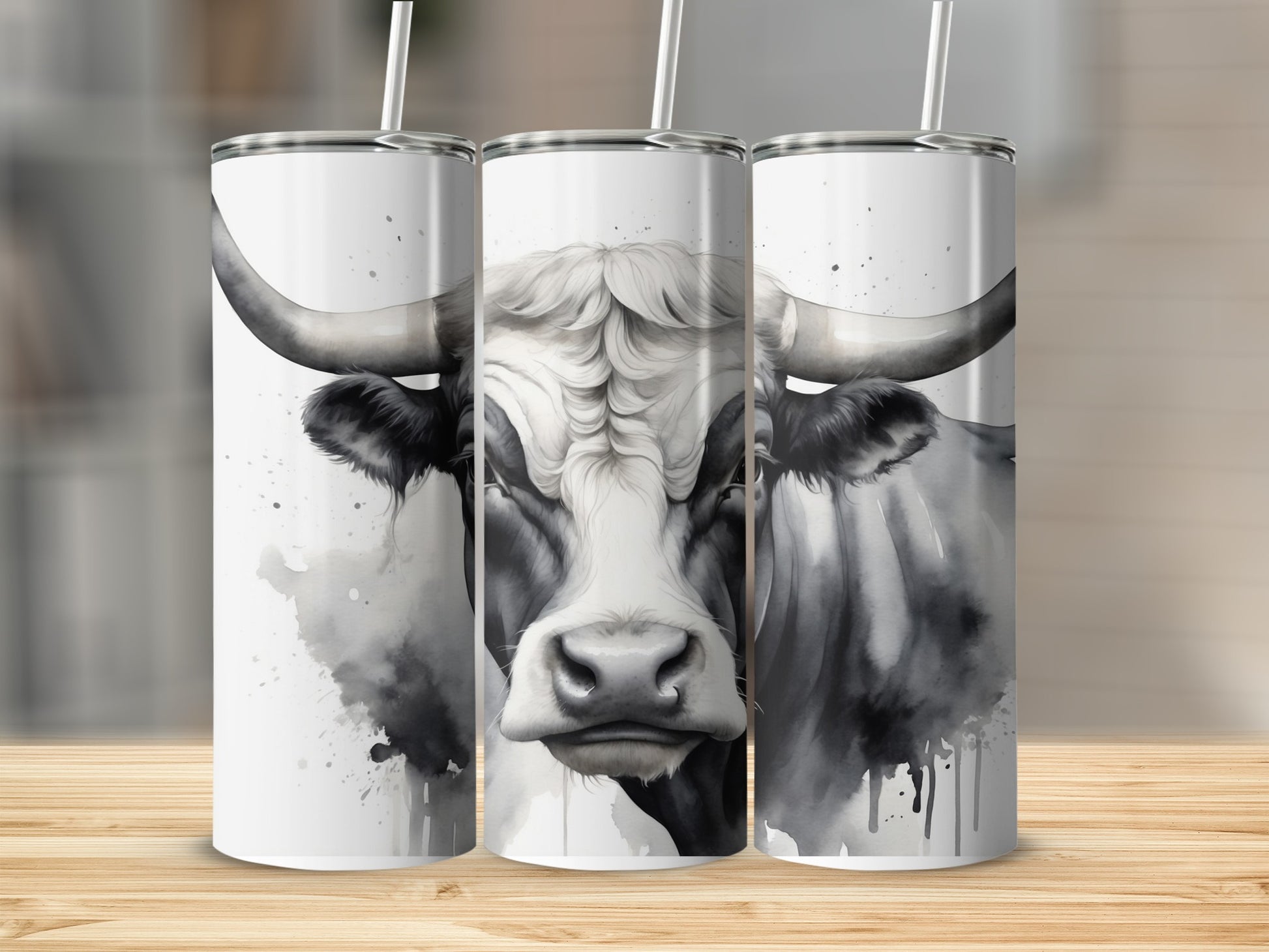 Black and white watercolor bull portrait on three tumblers.