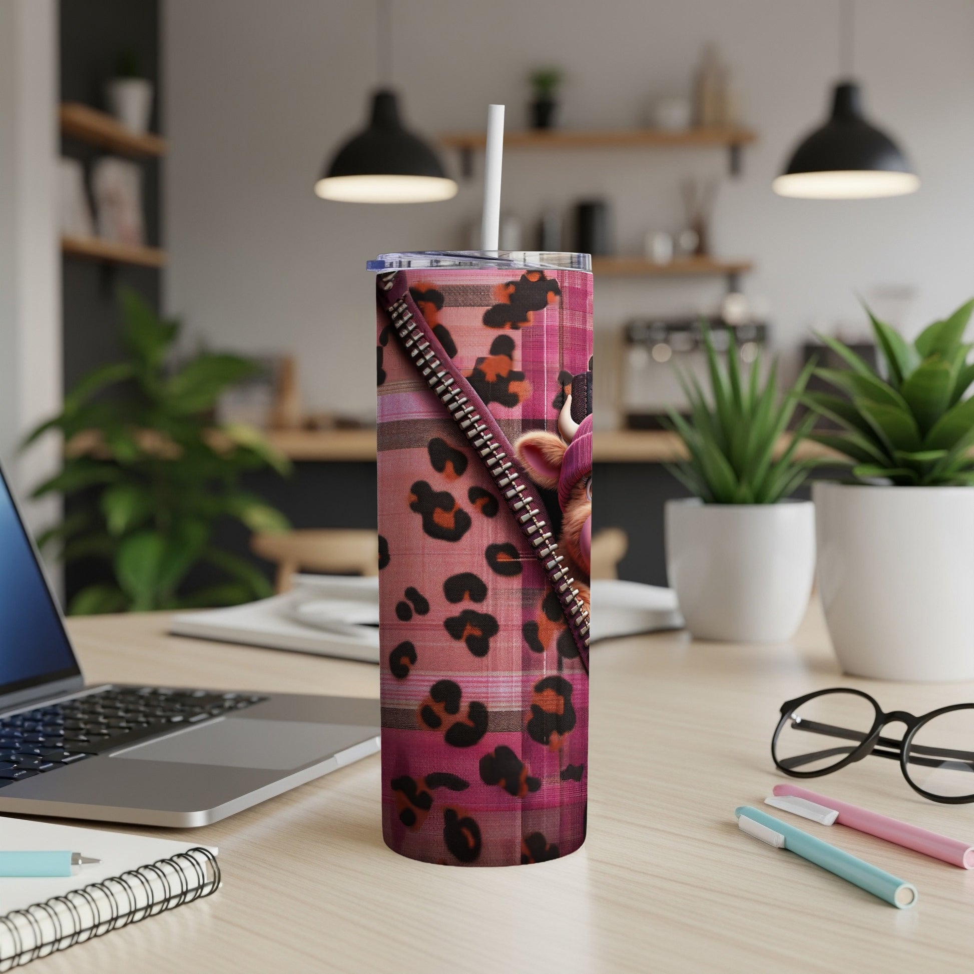 Pink cheetah print tumbler with zipper detail and straw.