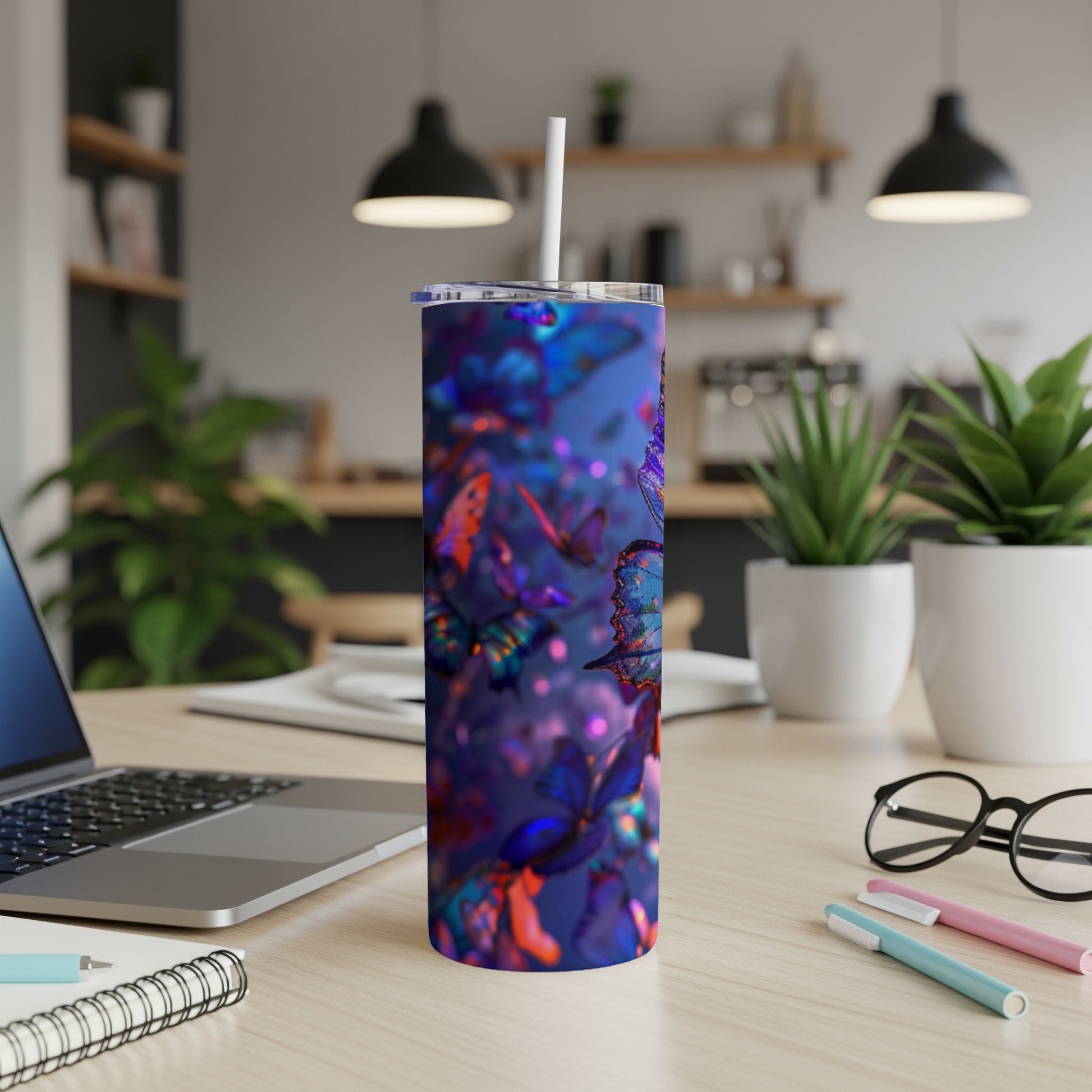 Tumbler with colorful butterflies on a blue, bokeh background.