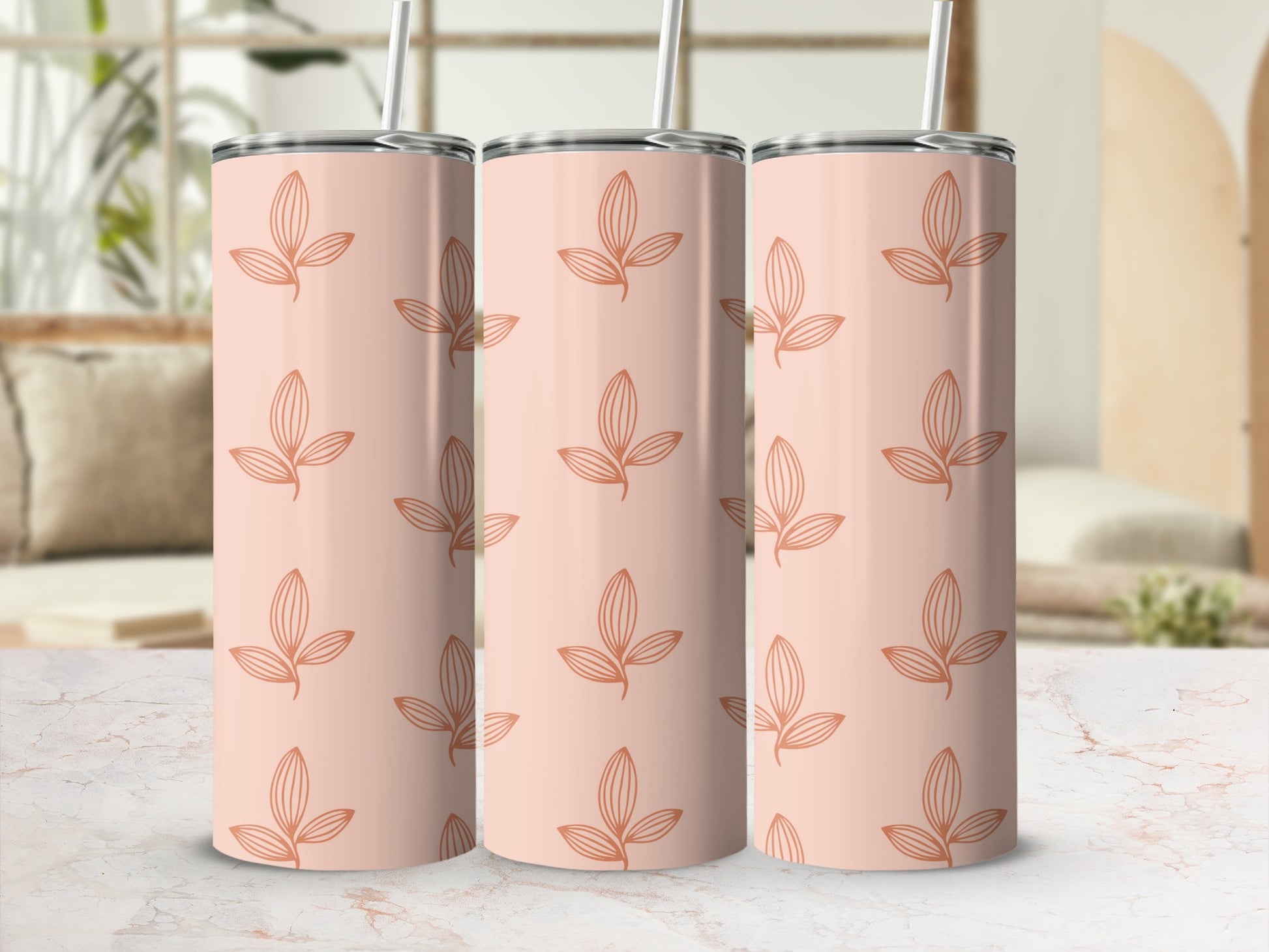 Three peach-colored tumblers with repeating leaf pattern in soft orange.