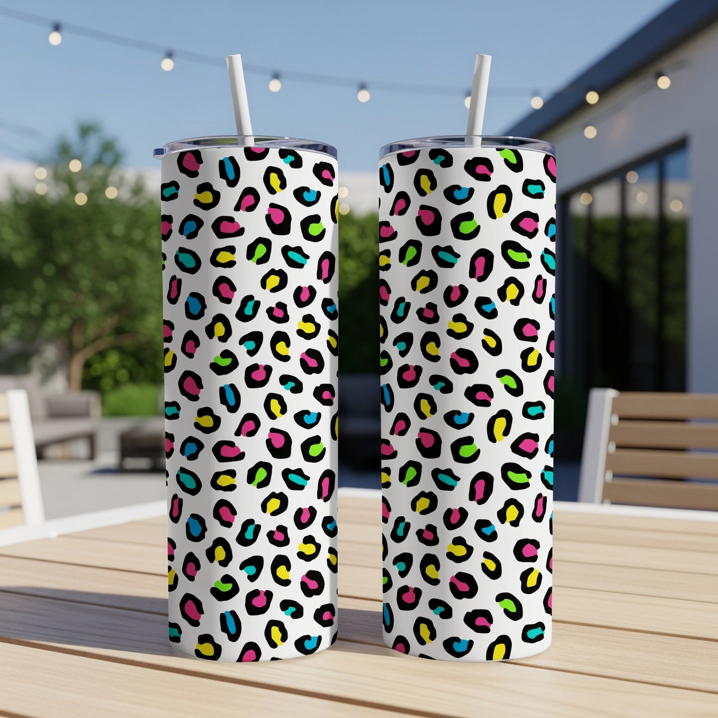 Two tall tumblers with a white background and colorful leopard print pattern.