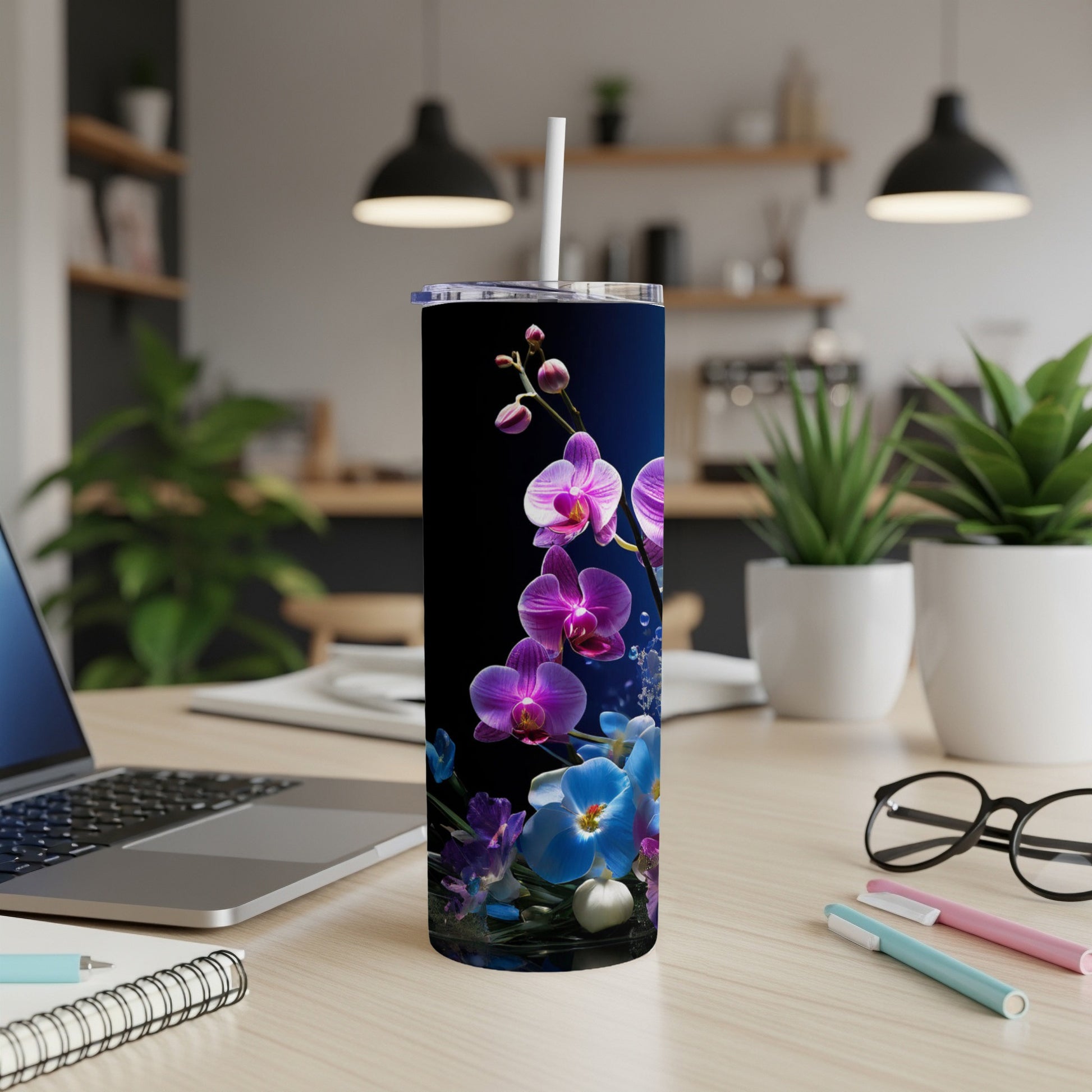 Tall skinny tumbler with purple and blue orchids on a dark background.
