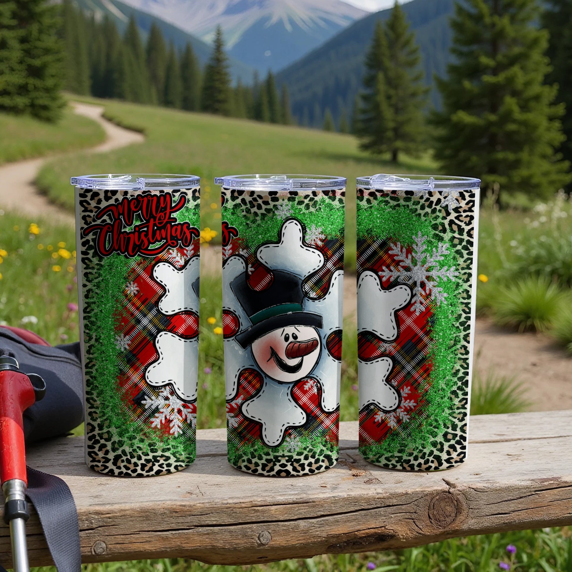 Three snowmen tumblers with plaid and leopard print designs.