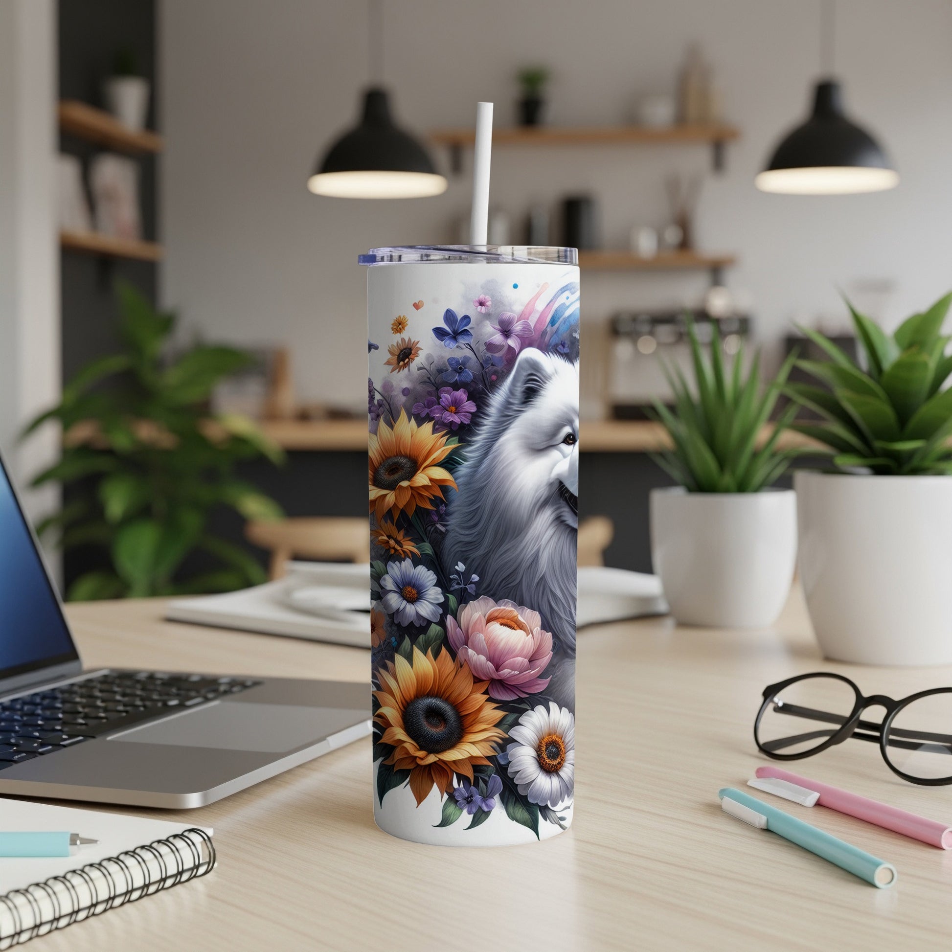 White dog with flowers on a white insulated tumbler with straw.