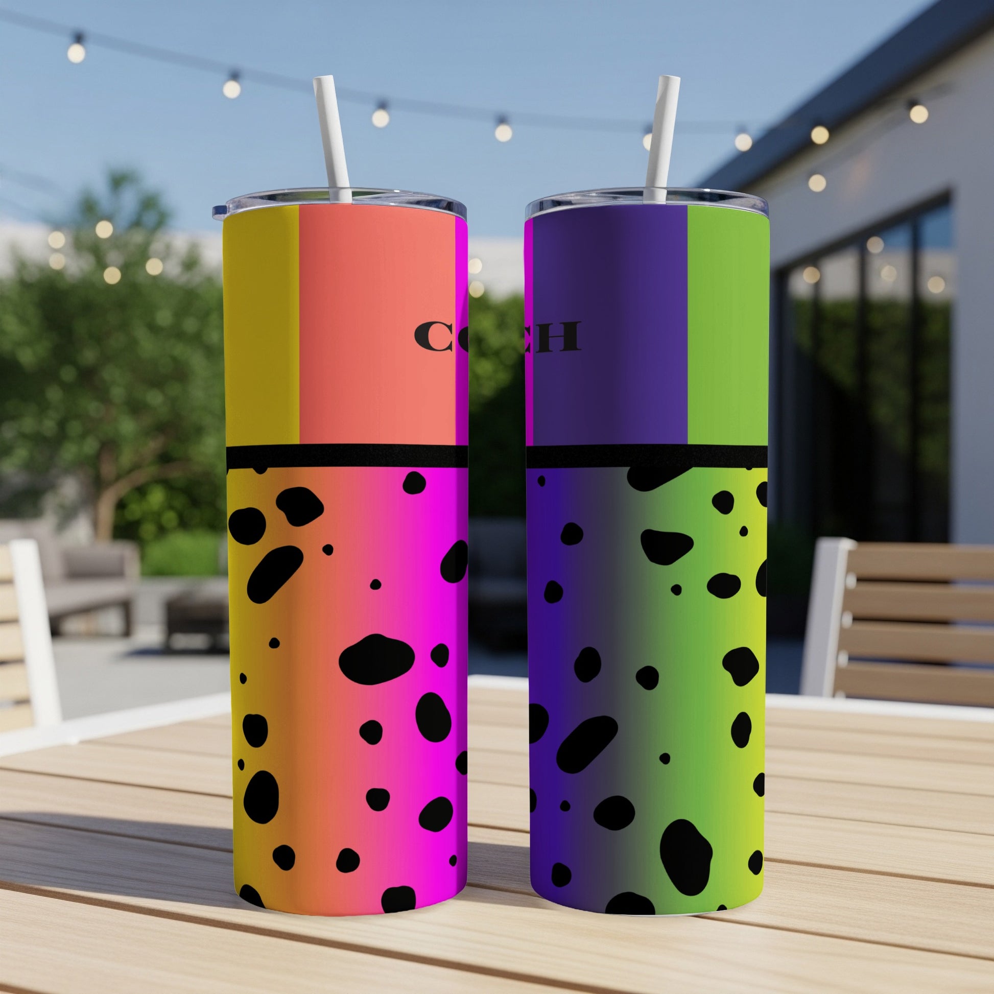 Two tall tumblers with colorful blocks and black spots, bearing the "COACH" logo.