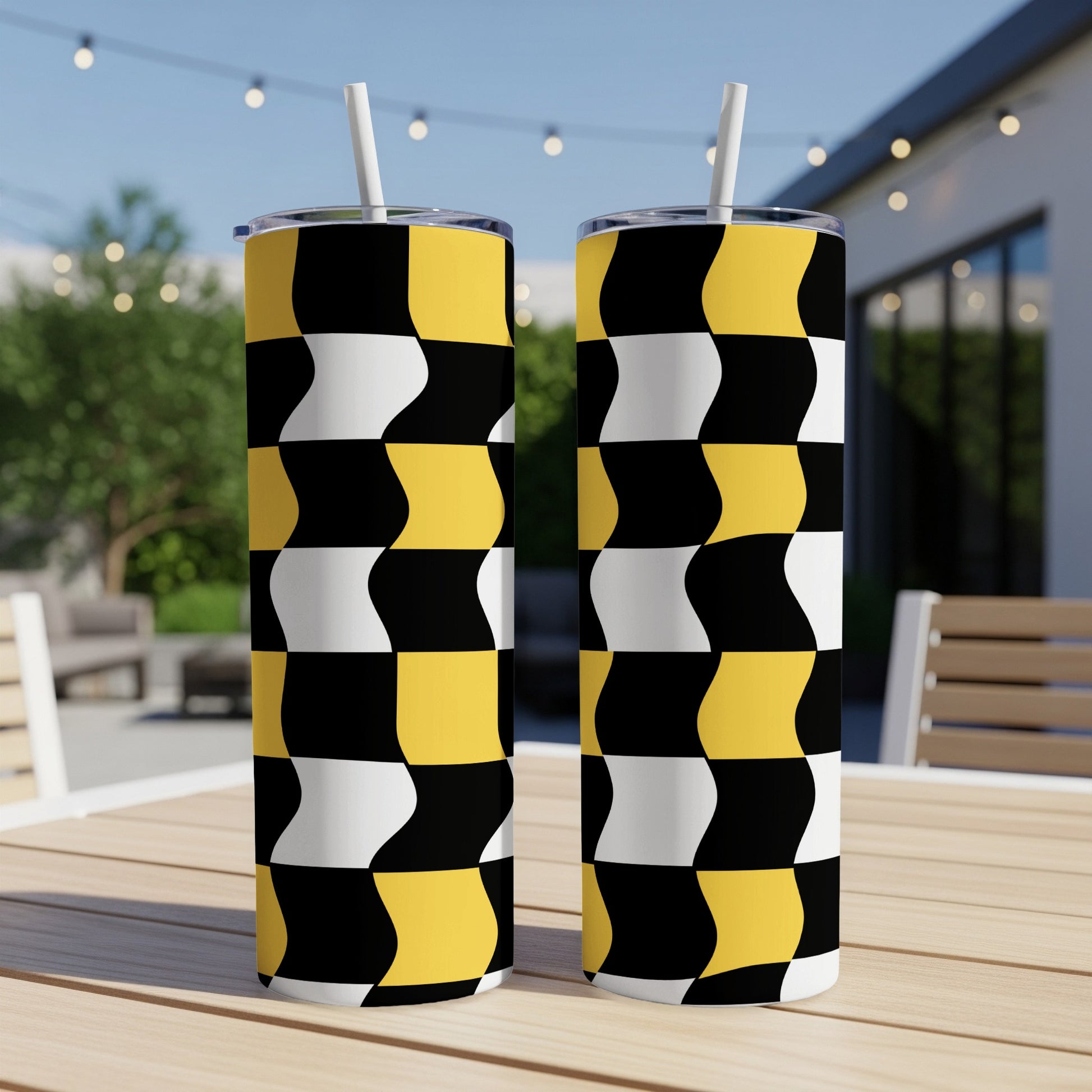 Two tumblers with a black, white, and yellow checkered pattern.