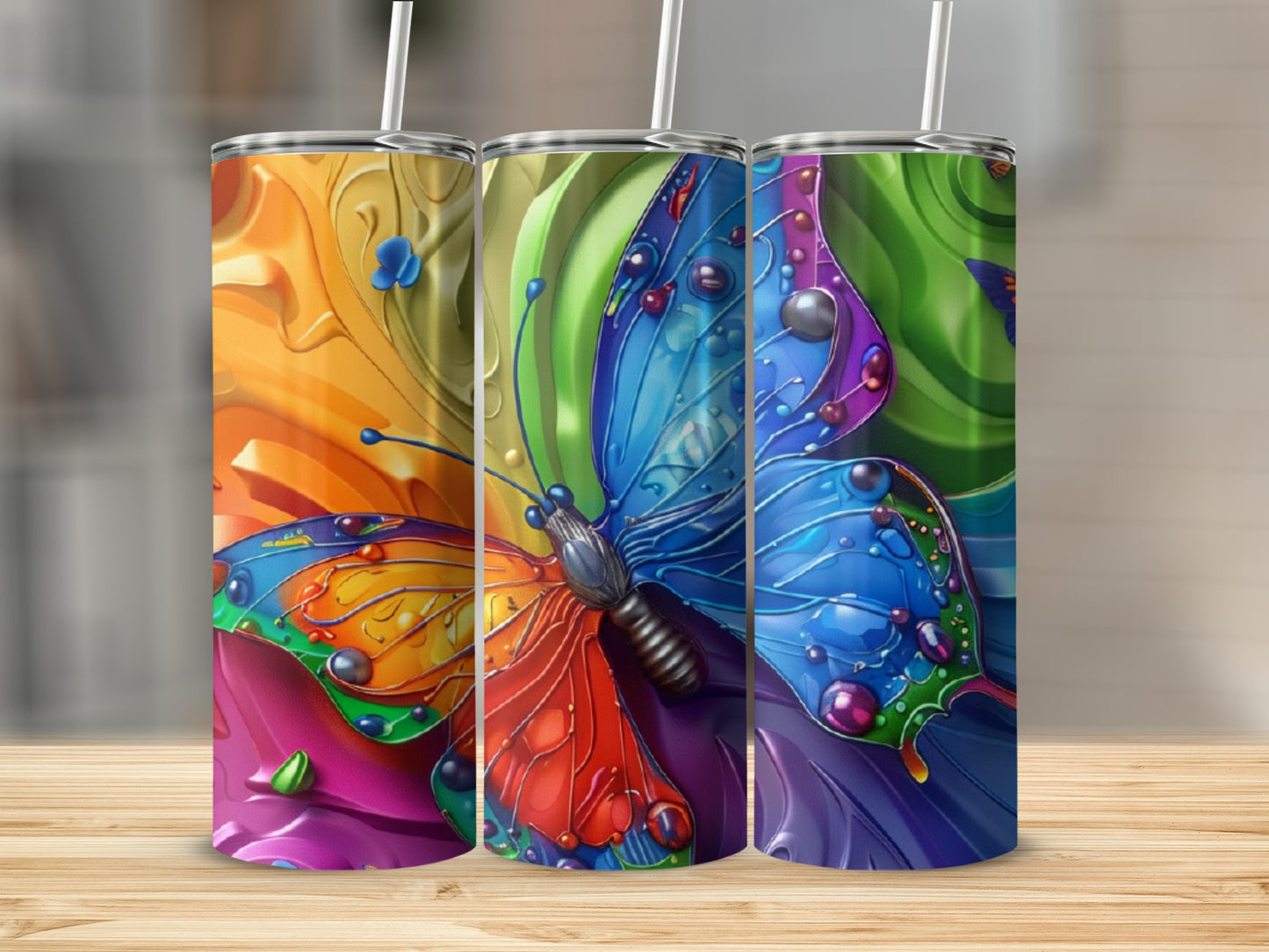 Three colorful tumblers featuring a vibrant butterfly design.