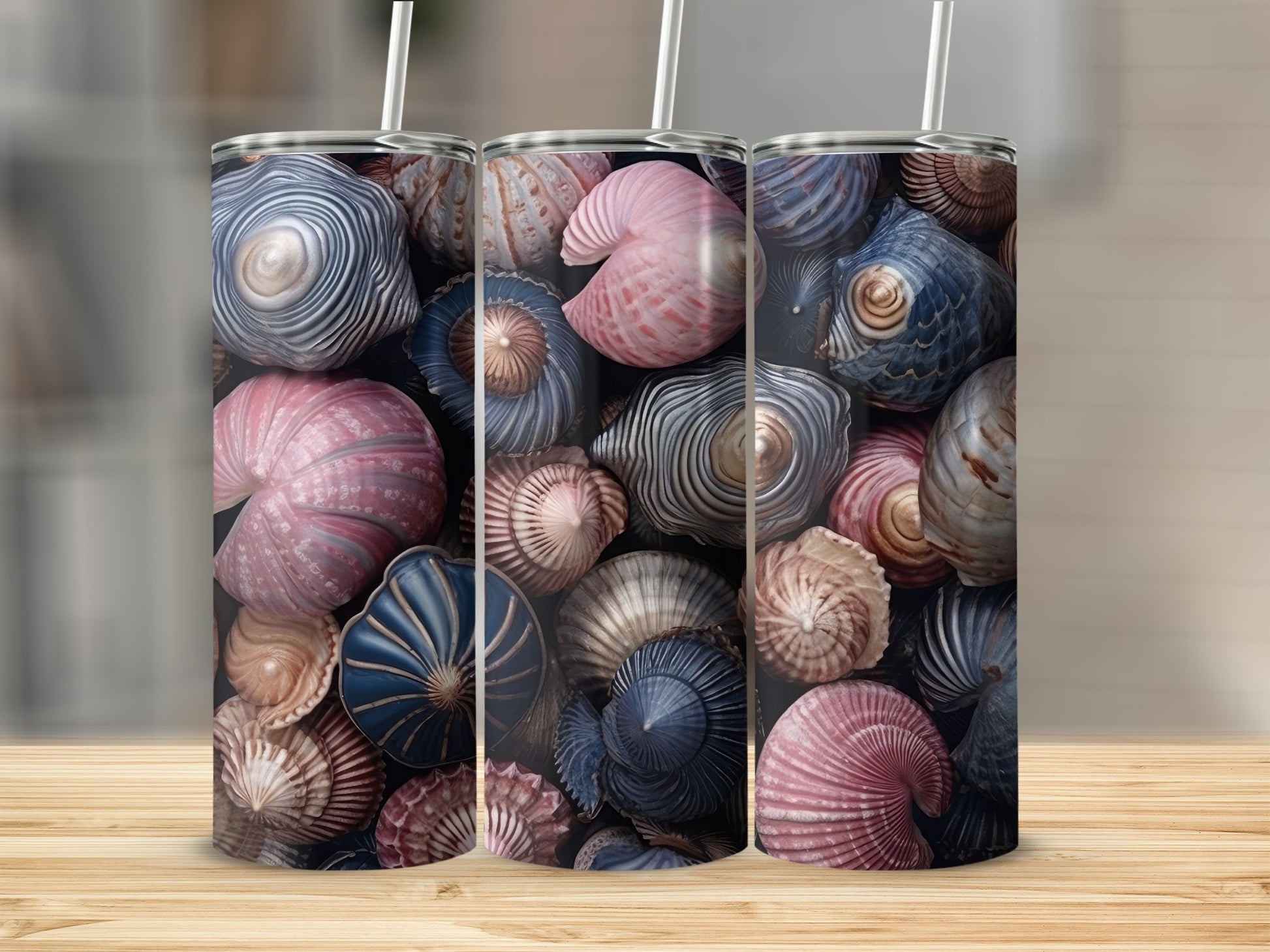 Three tumblers featuring a colorful pattern of various seashells.