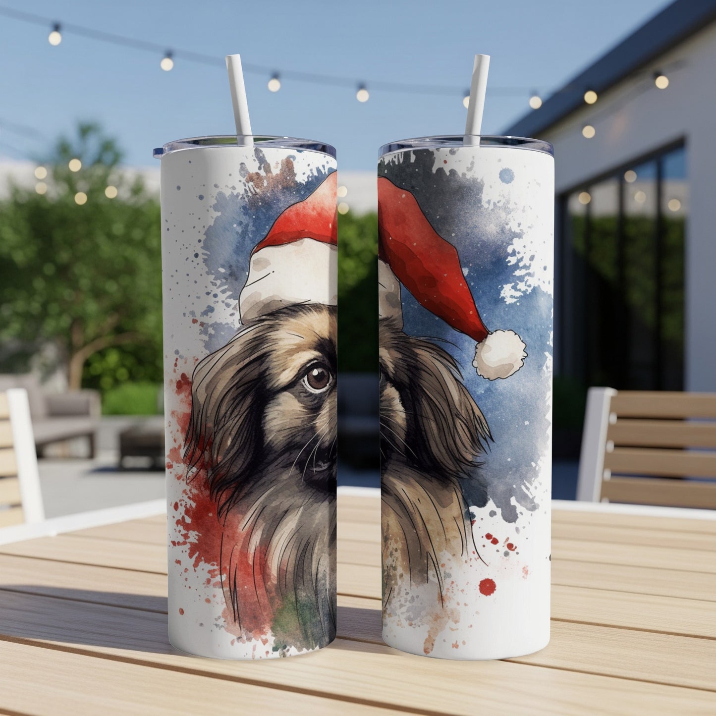 Two tumblers with a watercolor painting of a dog wearing a Santa hat.