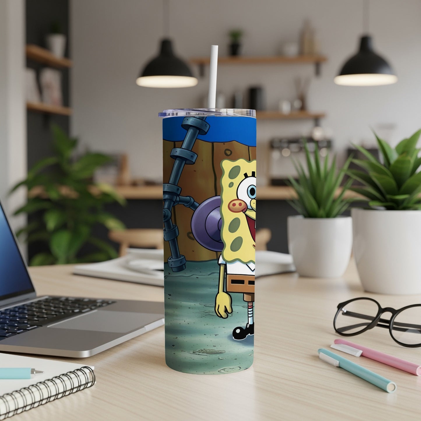 SpongeBob SquarePants character on a blue patterned tumbler with a straw.