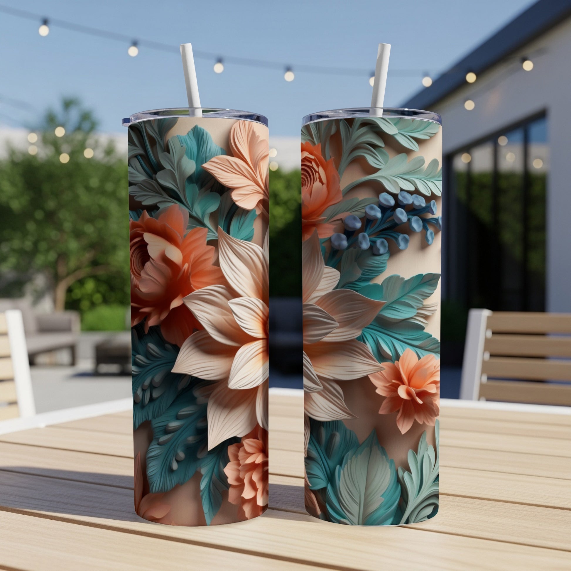 Two floral tumblers with straw and intricate botanical design.
