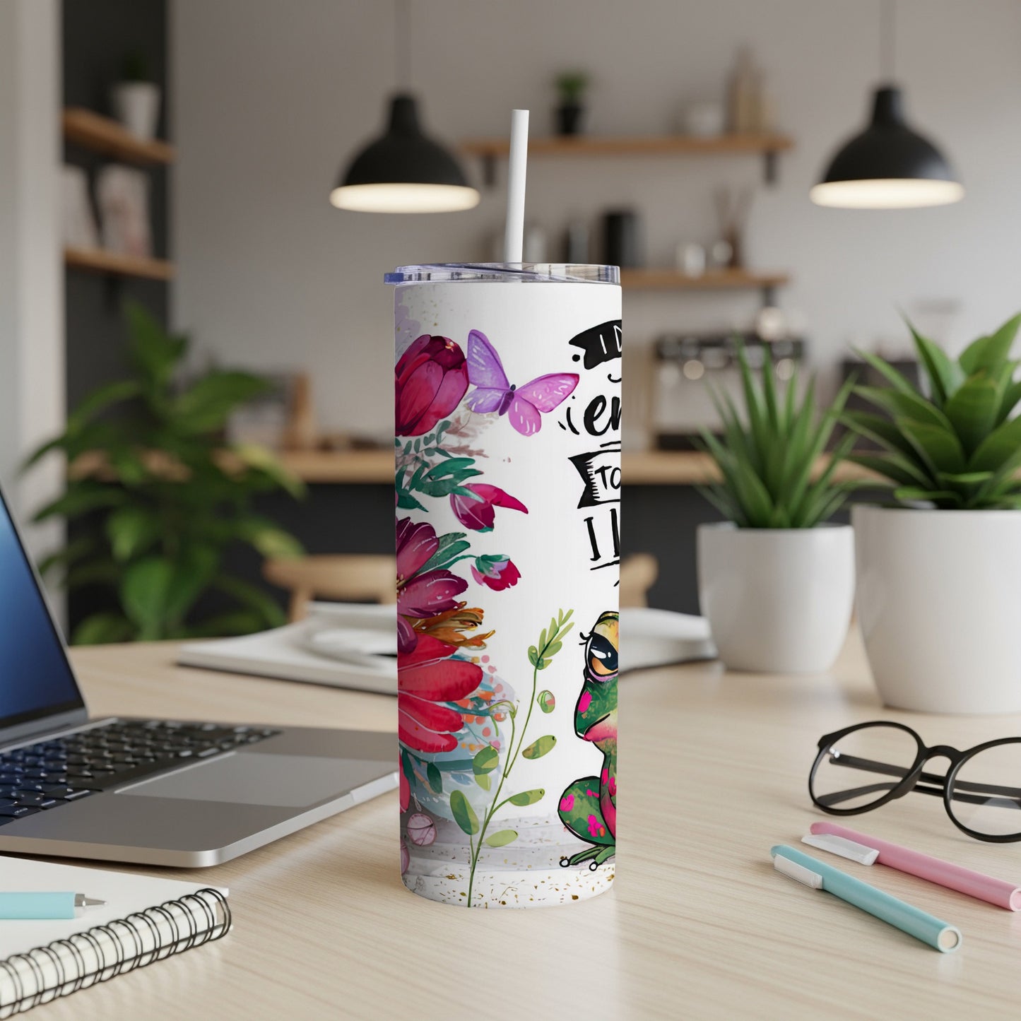 "I'm not crazy, my reality is just different" text on a tumbler with frogs and flowers.